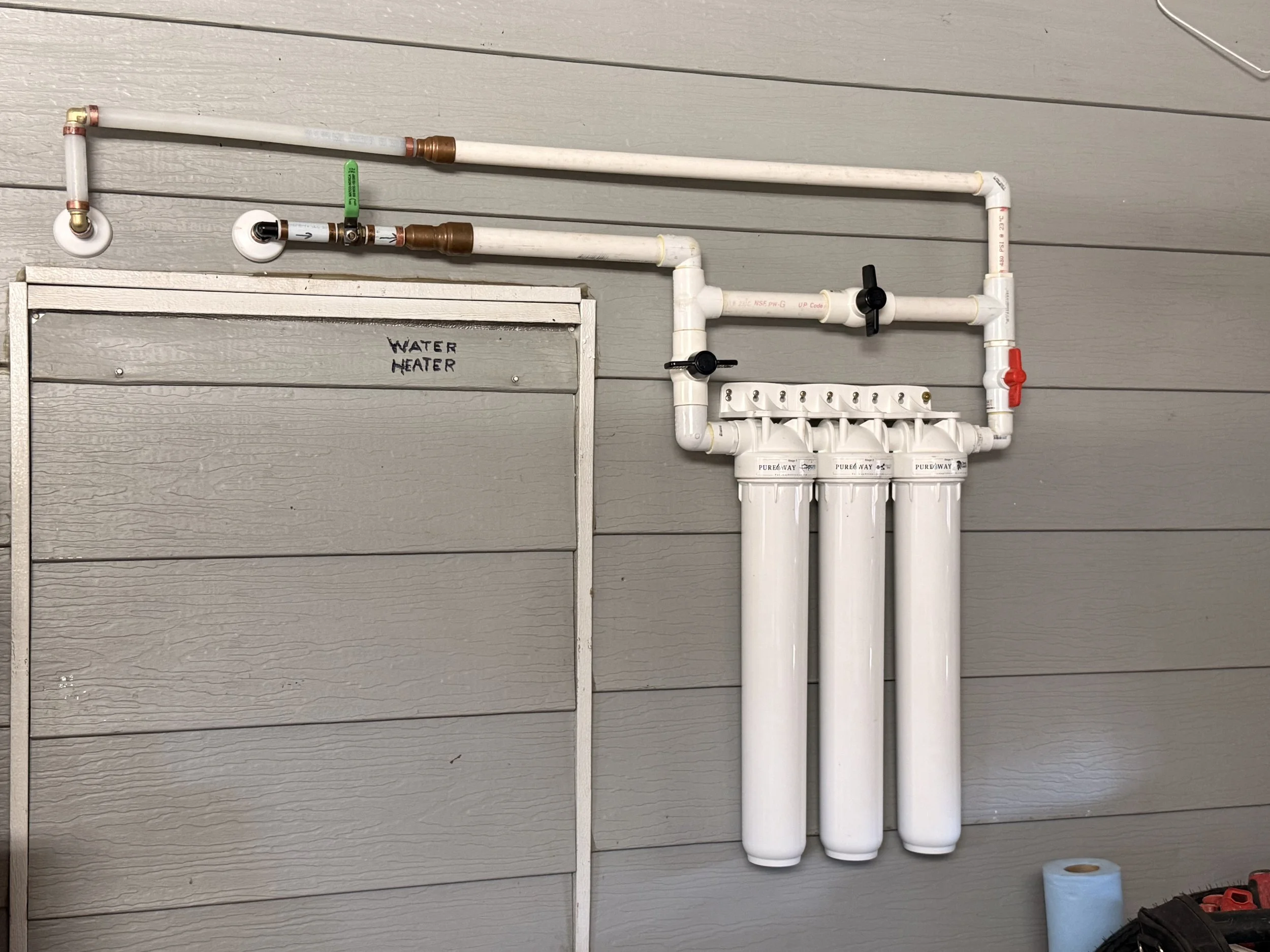 A whole house filter attached to the side of a mobile home in Daytona beach Florida