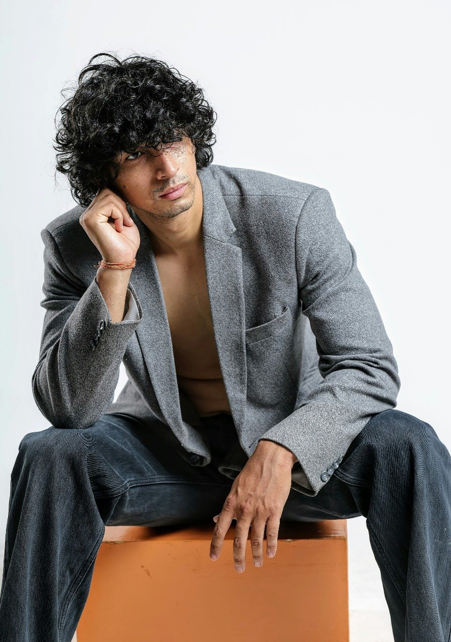 Asian guy sitting with great hair cool pose