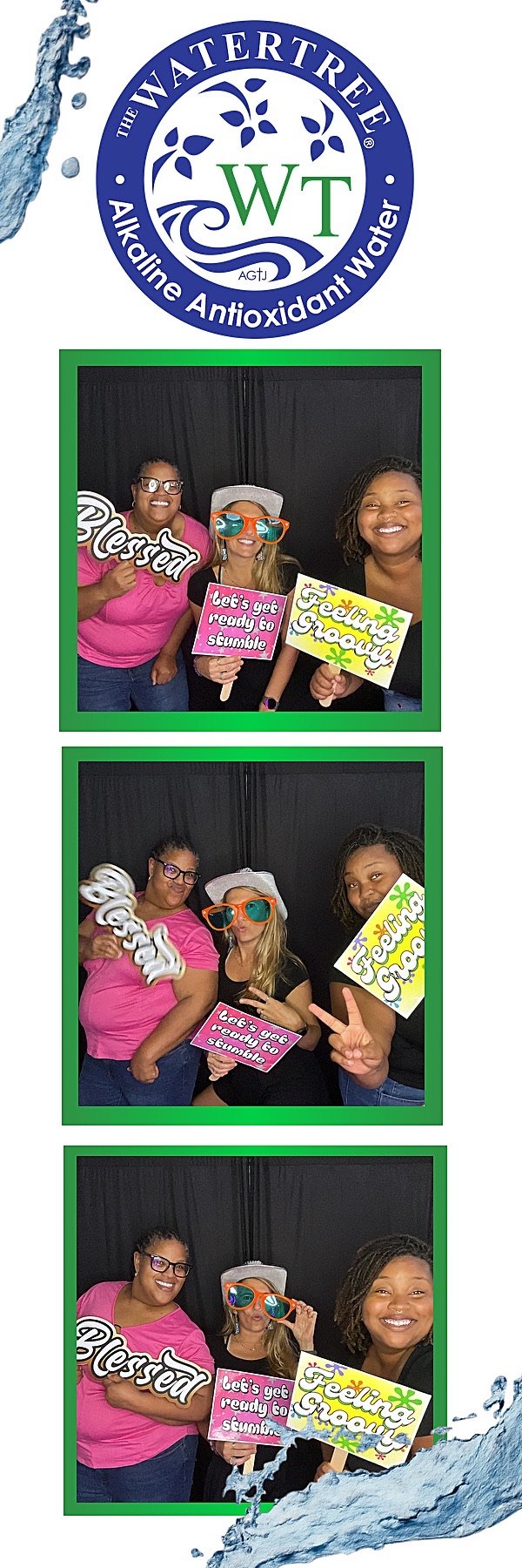 Group of three women at a photo booth celebrating WaterTree alkaline antioxidant water, holding signs with cheerfully written messages, wearing playful accessories, and smiling in front of a black backdrop.