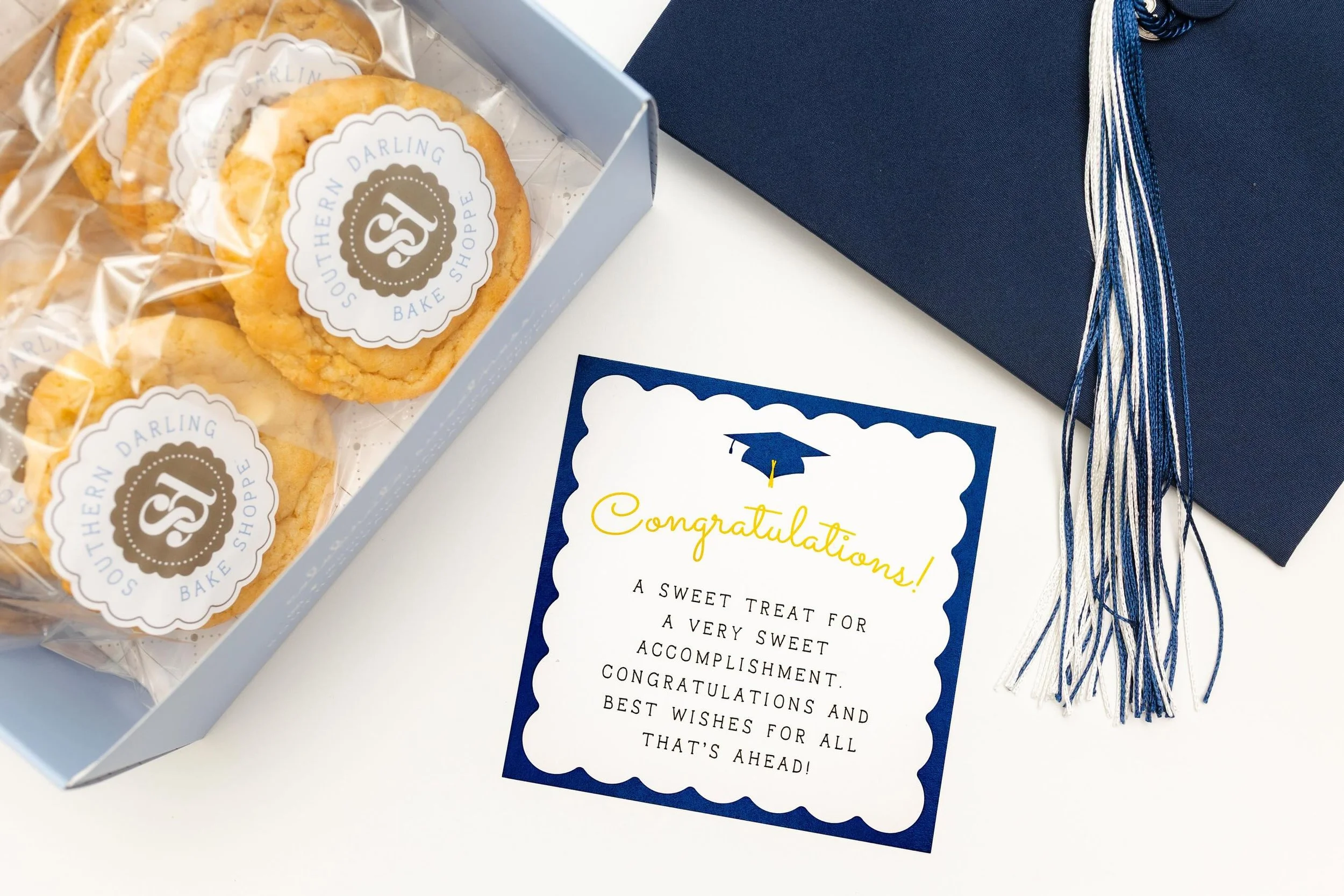 Graduation season is here! We&rsquo;ve just launched the perfect grad gift! Our Graduation Cookie Box is available on either a full dozen or half dozen! Pick your flavors and treat your grad to a sweet gift! Beautifully packaged with a navy bow and G