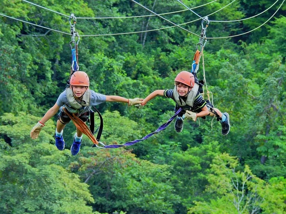Family ziplining through the rainforest in Costa Rica