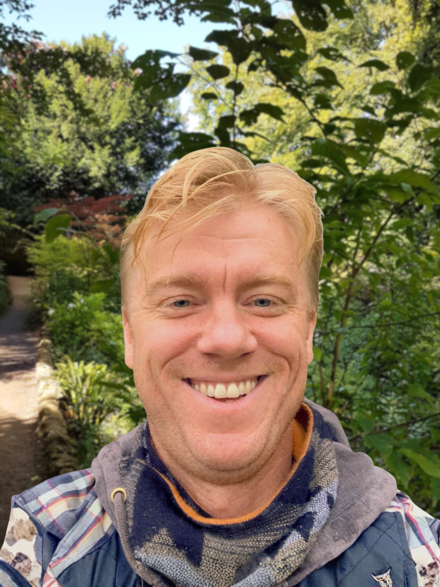 Curtis: Wearing plaid hoodie. He has reddish-blonde hair, and a big, warm smile.