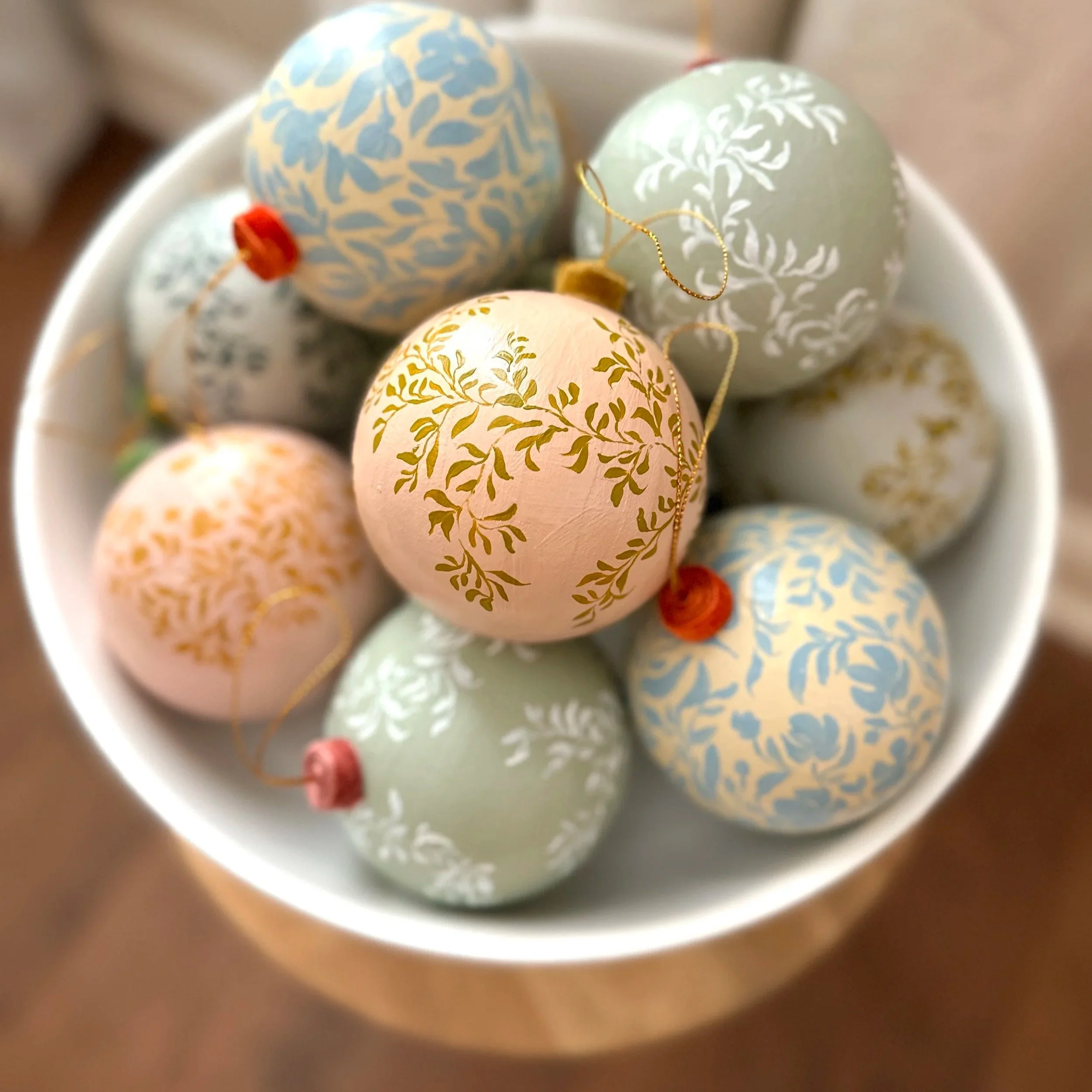 Bowl of hand painted holiday ornaments by Blair Frazier Art