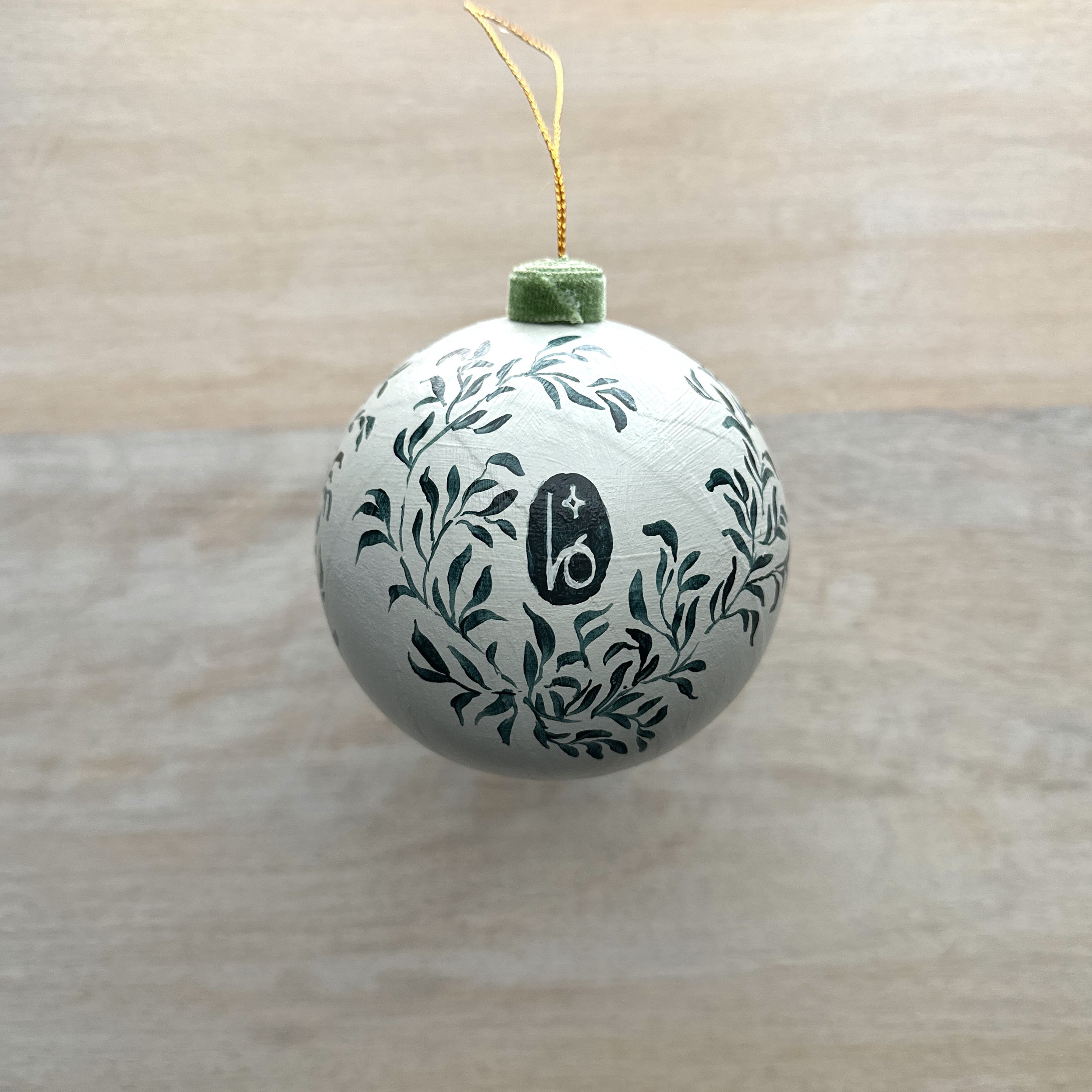 Navy and light blue Christmas ornament with hand painted botanicals by Blair Frazier Art