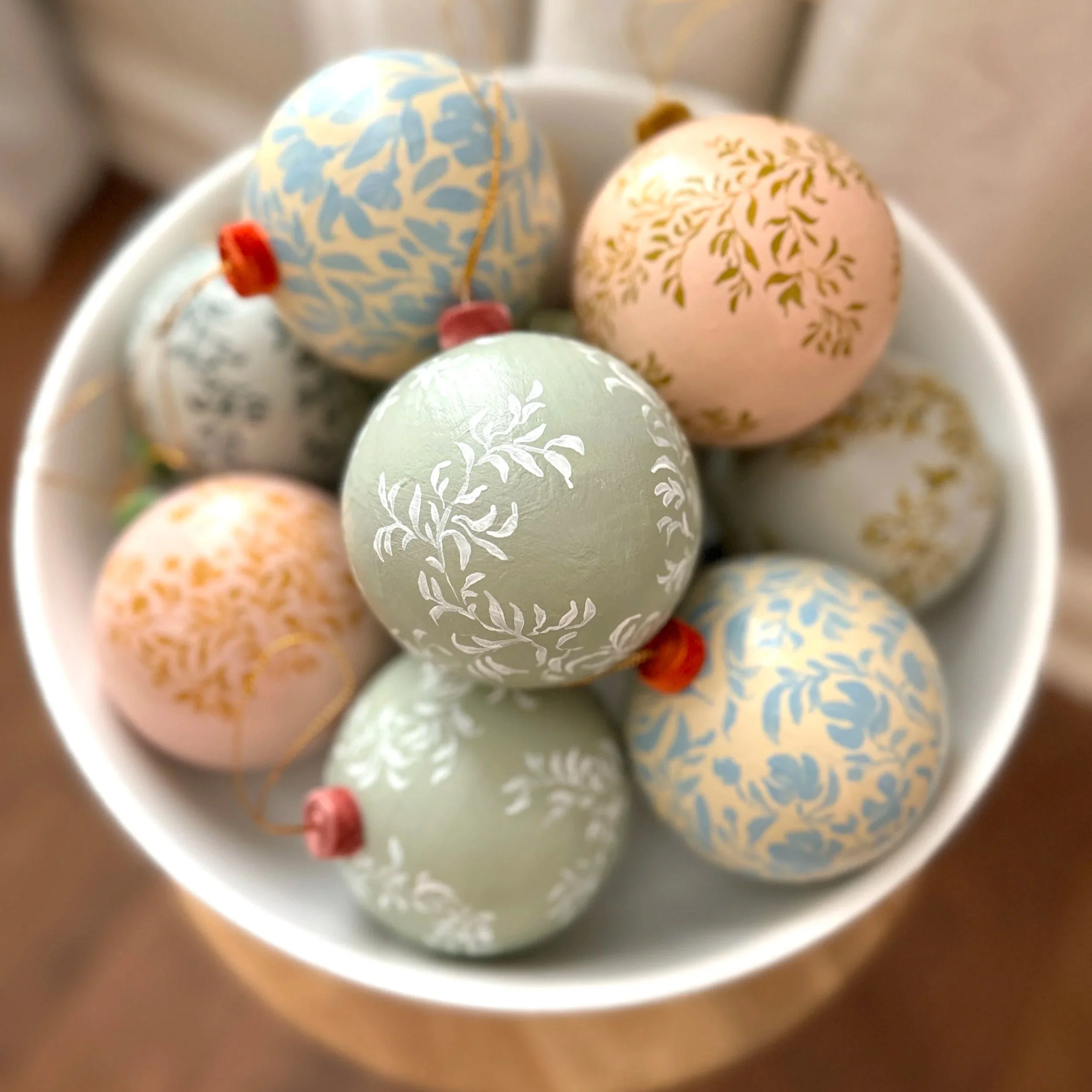 Bowl of hand painted paper mache ornaments by Blair Frazier Art