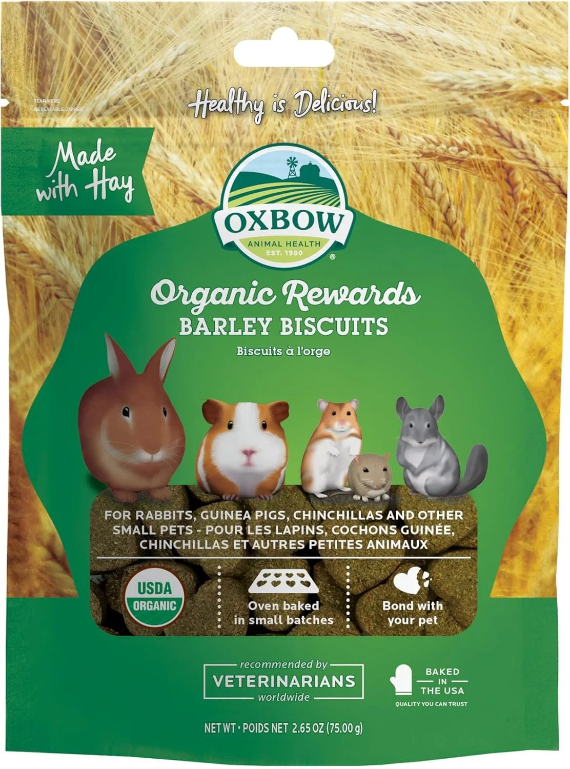 Package of Oxbow Organic Rewards barley biscuits for small pets, featuring illustrations of a rabbit, guinea pig, hamster, mouse, and chinchilla against a background of hay, with labels indicating organic certification, oven baking, and pet bonding.