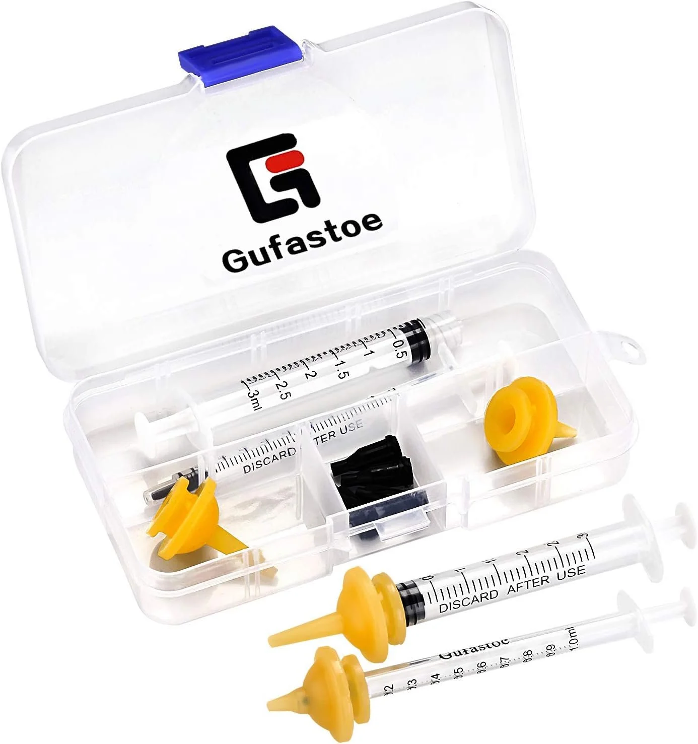 A transparent plastic container with a Gufastoe logo on the lid holds medical syringes and supplies, including a large syringe with yellow caps and black plungers, smaller syringes, and black needle caps.