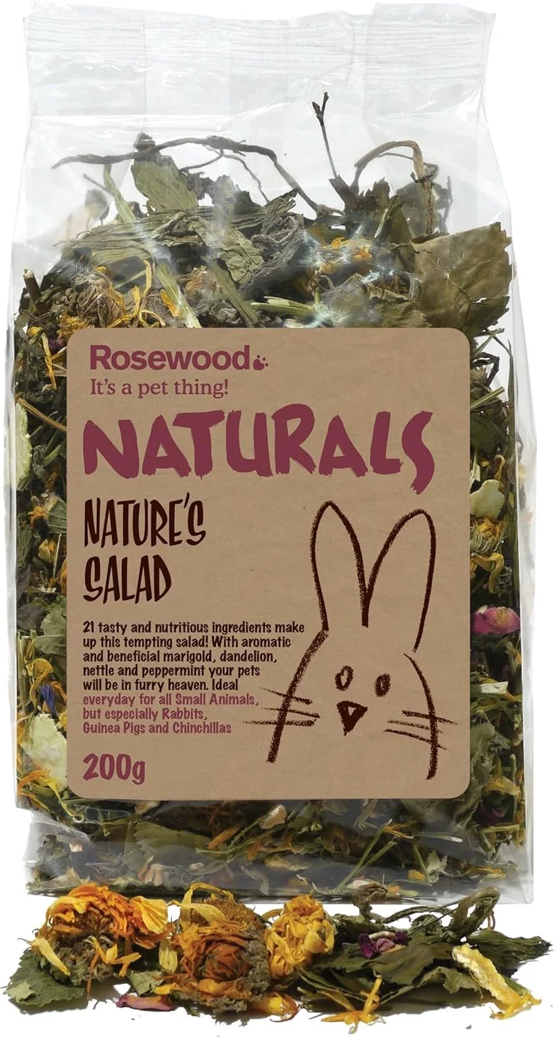 A clear plastic bag labeled 'Rosewood Naturals Nature's Salad' with dried herbs and flowers inside. The bag features a drawing of a bunny and text promoting it as a pet treat, suitable for small animals like rabbits, guinea pigs, and chinchillas. Dried petals and herbs are spilled out at the bottom.