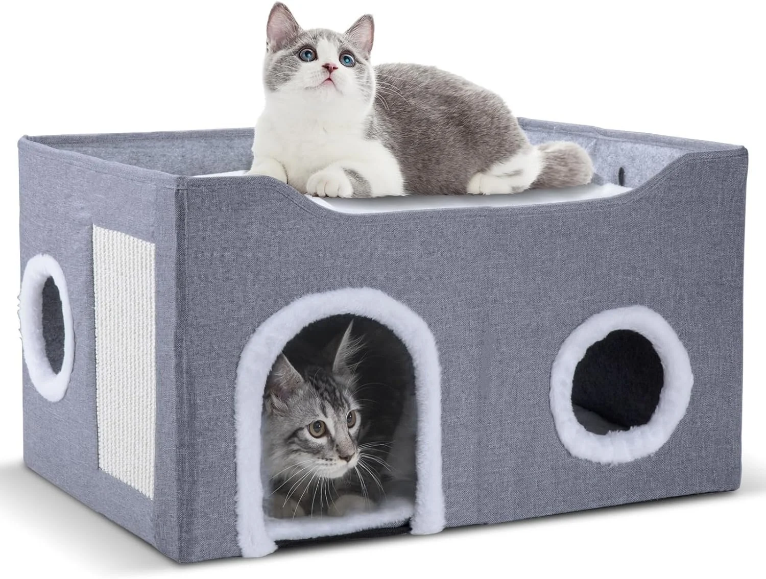 A gray fabric pet house shaped like a car with a cat inside and a kitten on top. The kitten is lying on top of the house, and the cat is peeking out of the entrance.