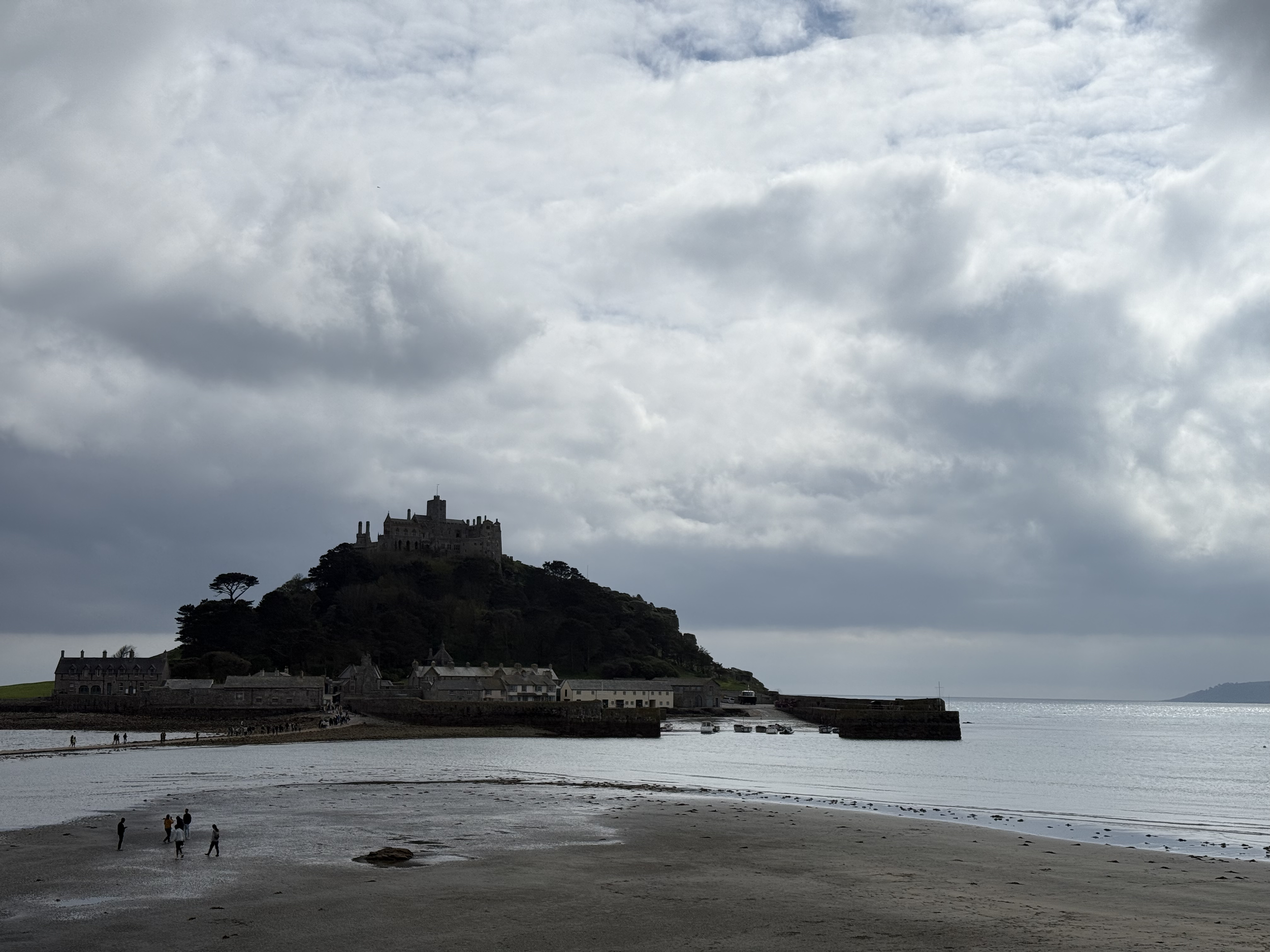 Exploring St Michael's Mount at low tide. This photo of the famous castle is a perfect blend of history, myth, and a unique coastal walk.