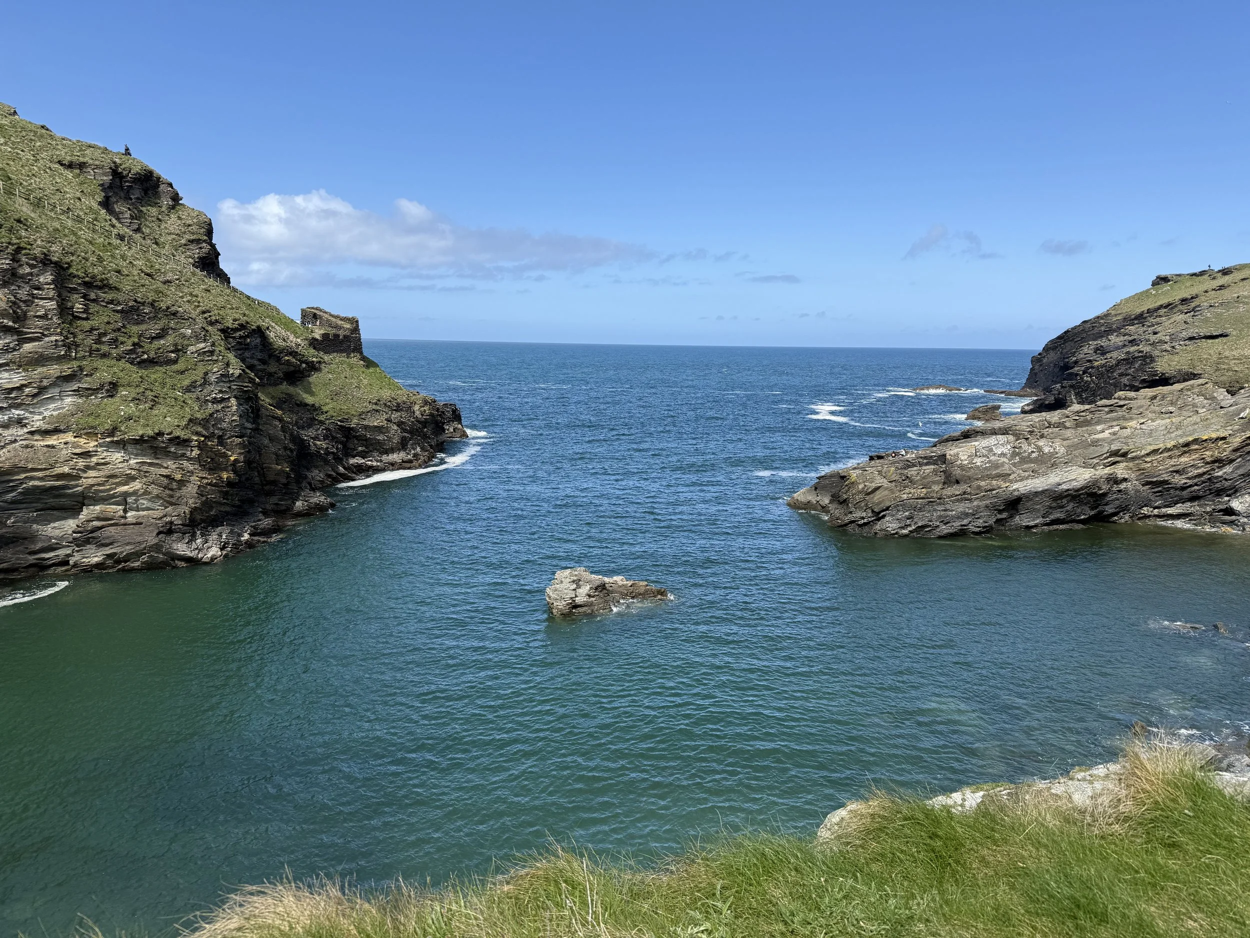 The stunning blue waters of Tintagel Cove are a beautiful sight. It's the perfect place to explore the sea and find your own adventure.