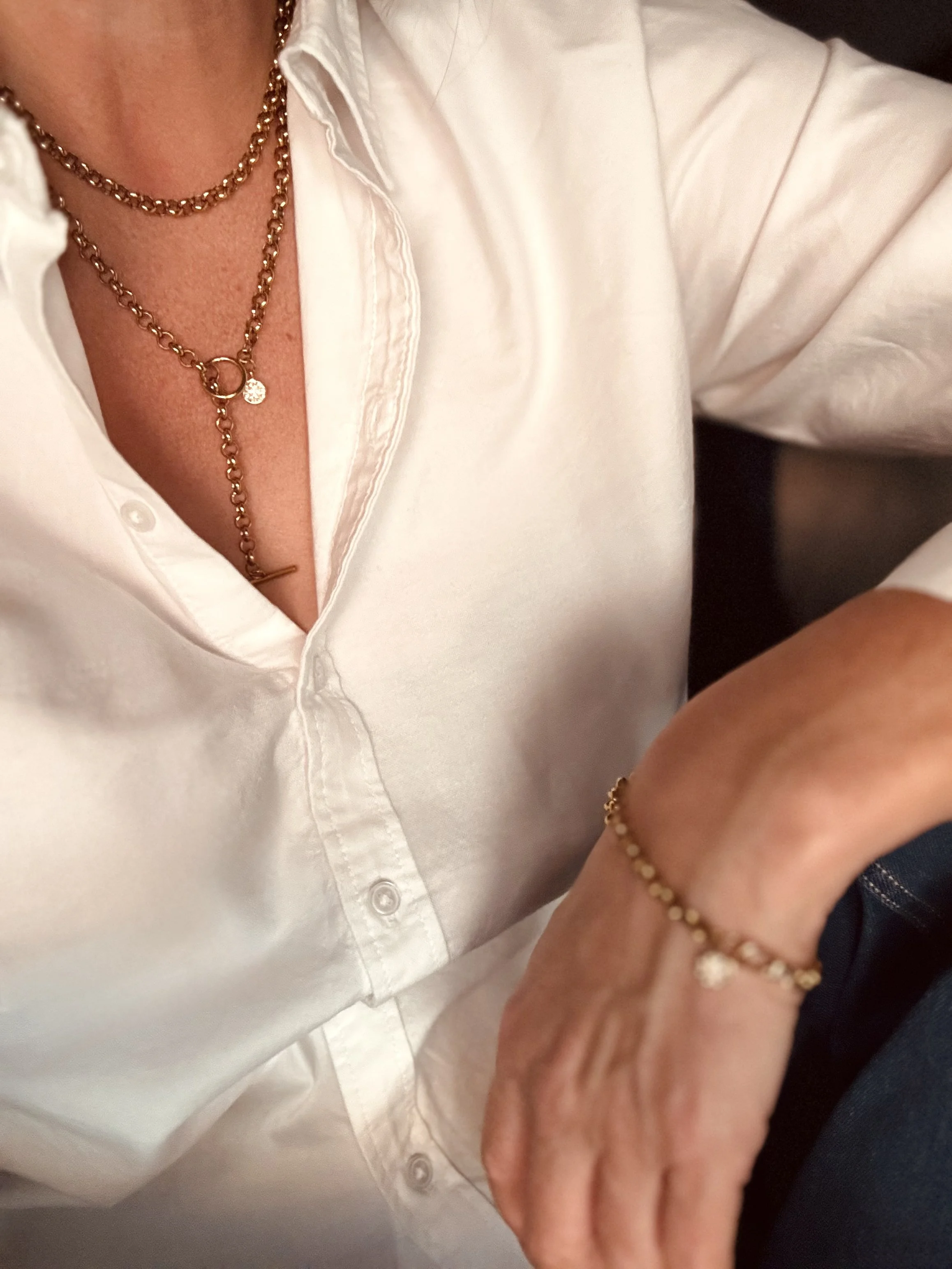Gold wrap chain lariat necklace displayed on a white jewellery bust. Available from Chain Rule Jewellery.