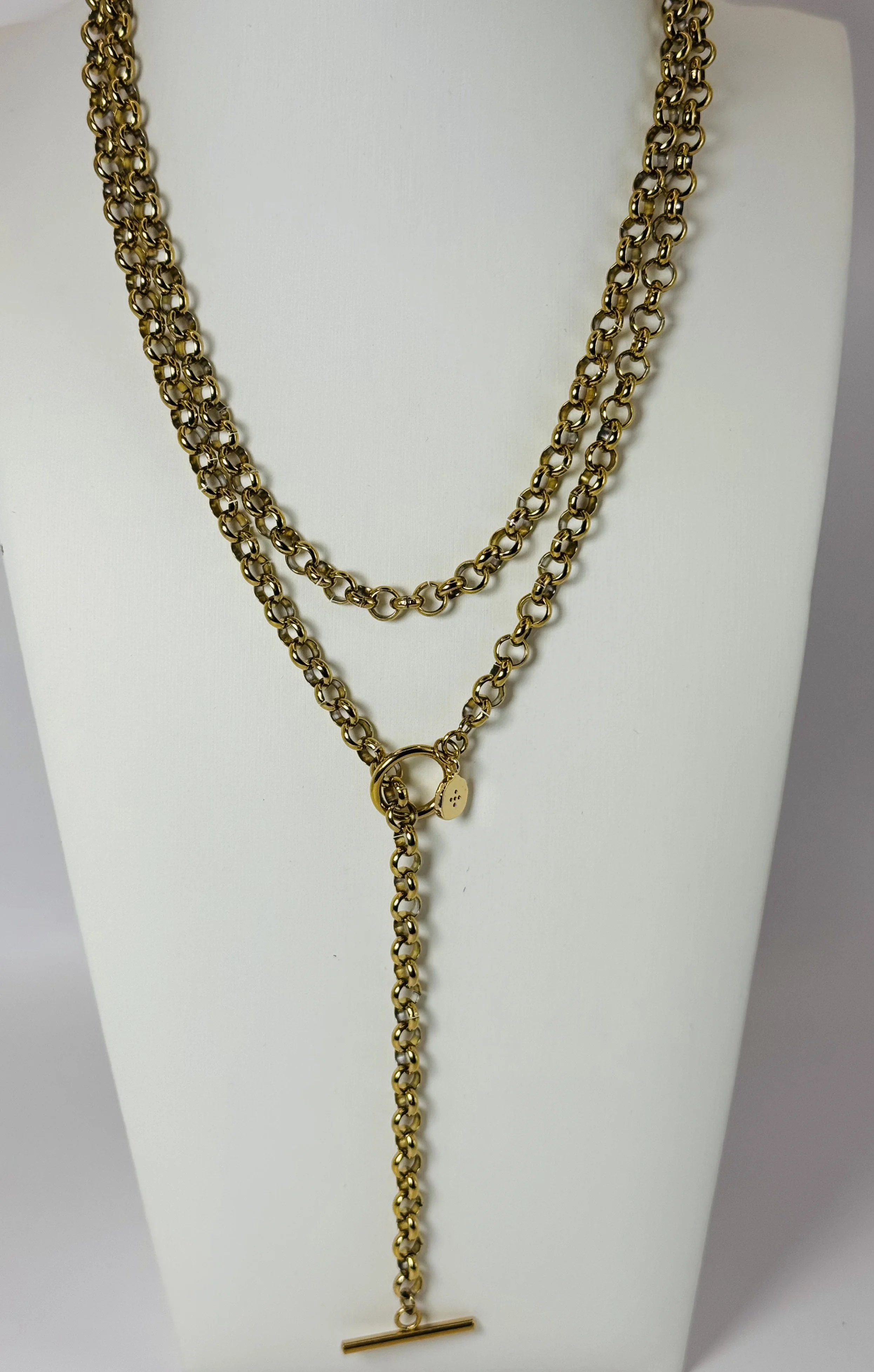 Gold wrap chain lariat necklace displayed on a white jewellery bust. Available from Chain Rule Jewellery.