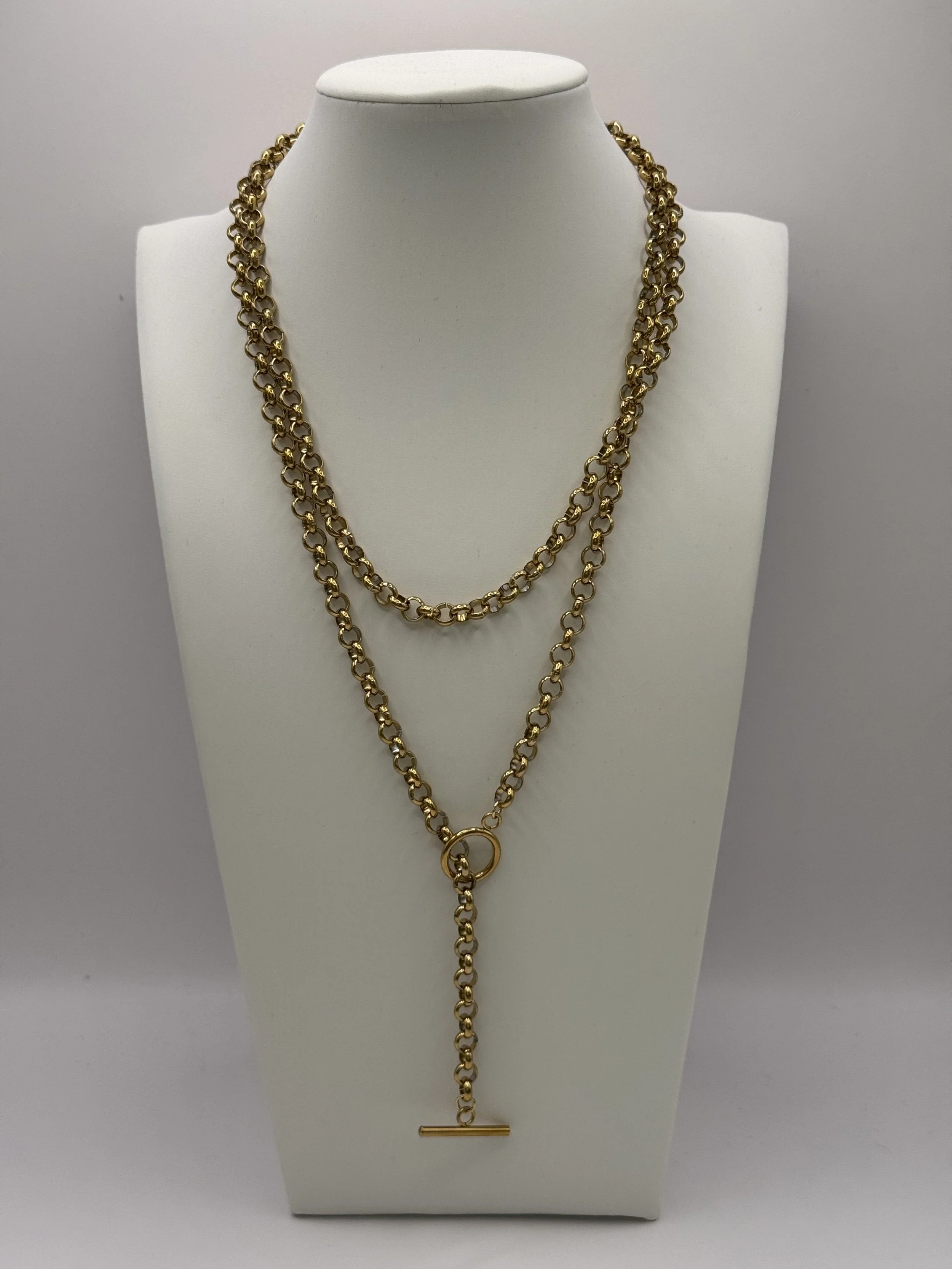 Gold wrap chain lariat necklace displayed on a white jewellery bust. Available from Chain Rule Jewellery.
