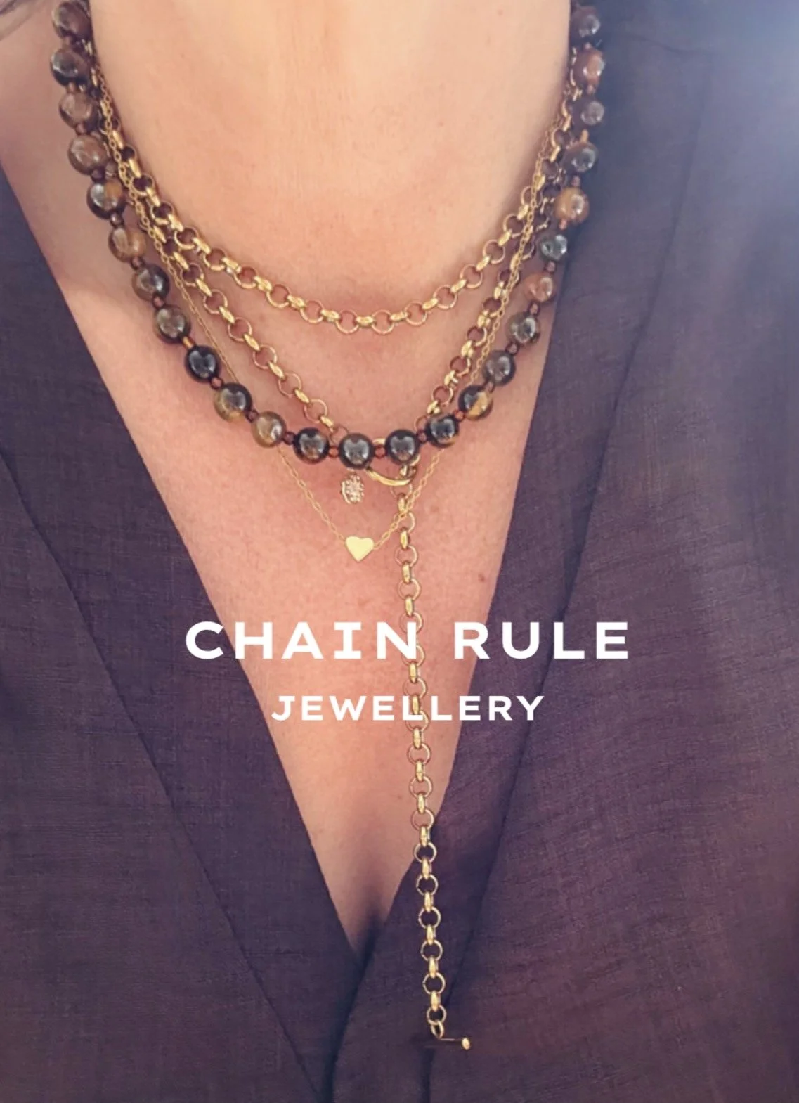 Close-up of a person's chest wearing layered gold and beaded necklaces with the words "CHAIN RULE JEWELLERY" overlayed.