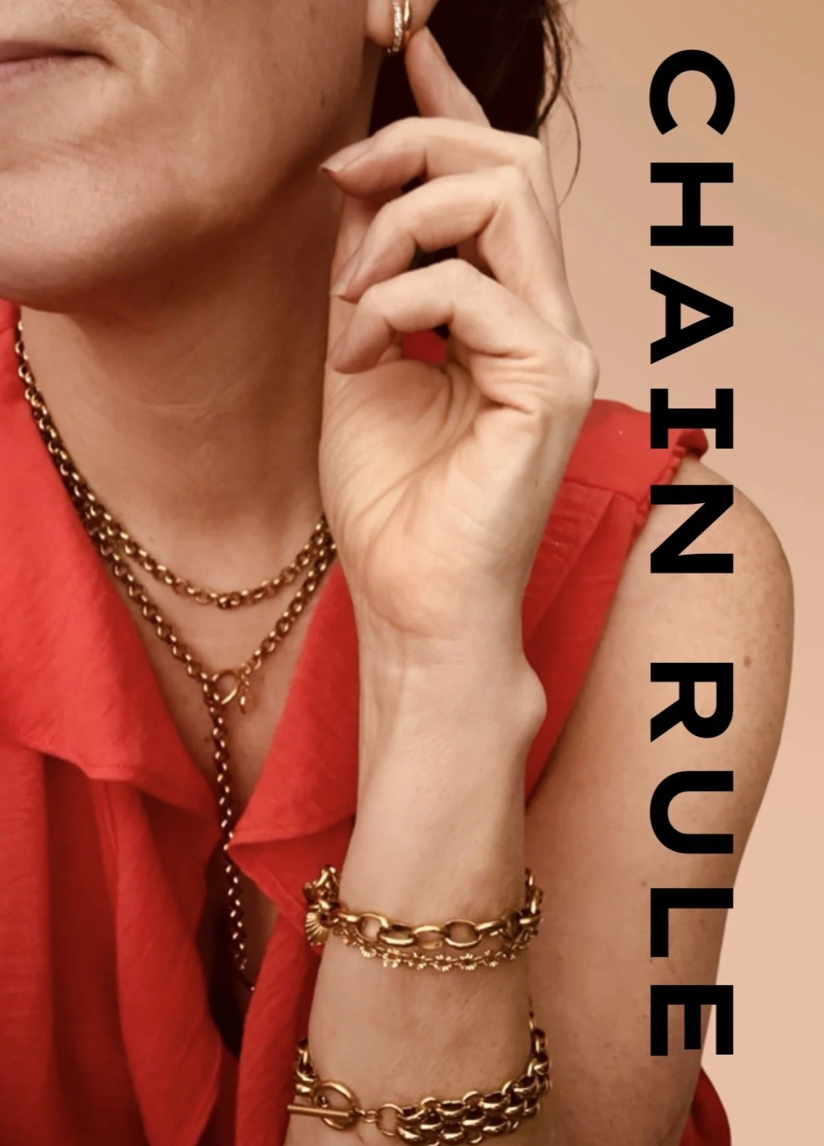 Close-up of a woman wearing gold jewelry including necklaces, bracelets, and earrings, with her hand resting near her face, dressed in a red sleeveless top, and the text 'CHAIN RULE' written vertically on the right side.