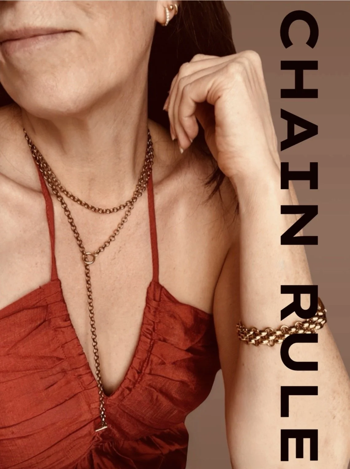 Gold wrap chain lariat necklace displayed on a white jewellery bust. Available from Chain Rule Jewellery.