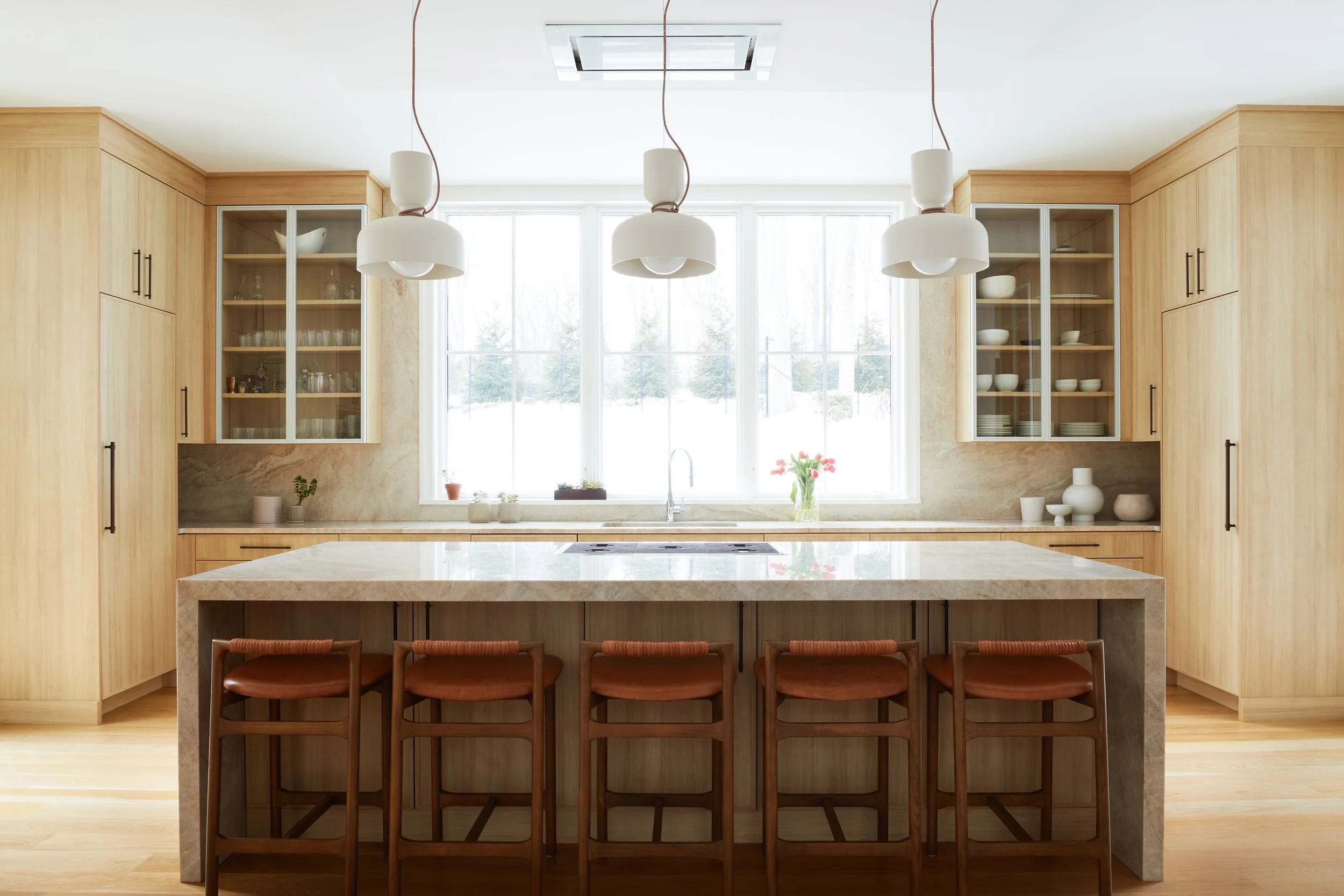 Kitchen island with pendant lighting and bar seating, kitchen design by Iris Michaels, Karen Berkemeyer Home, Westport, CT.