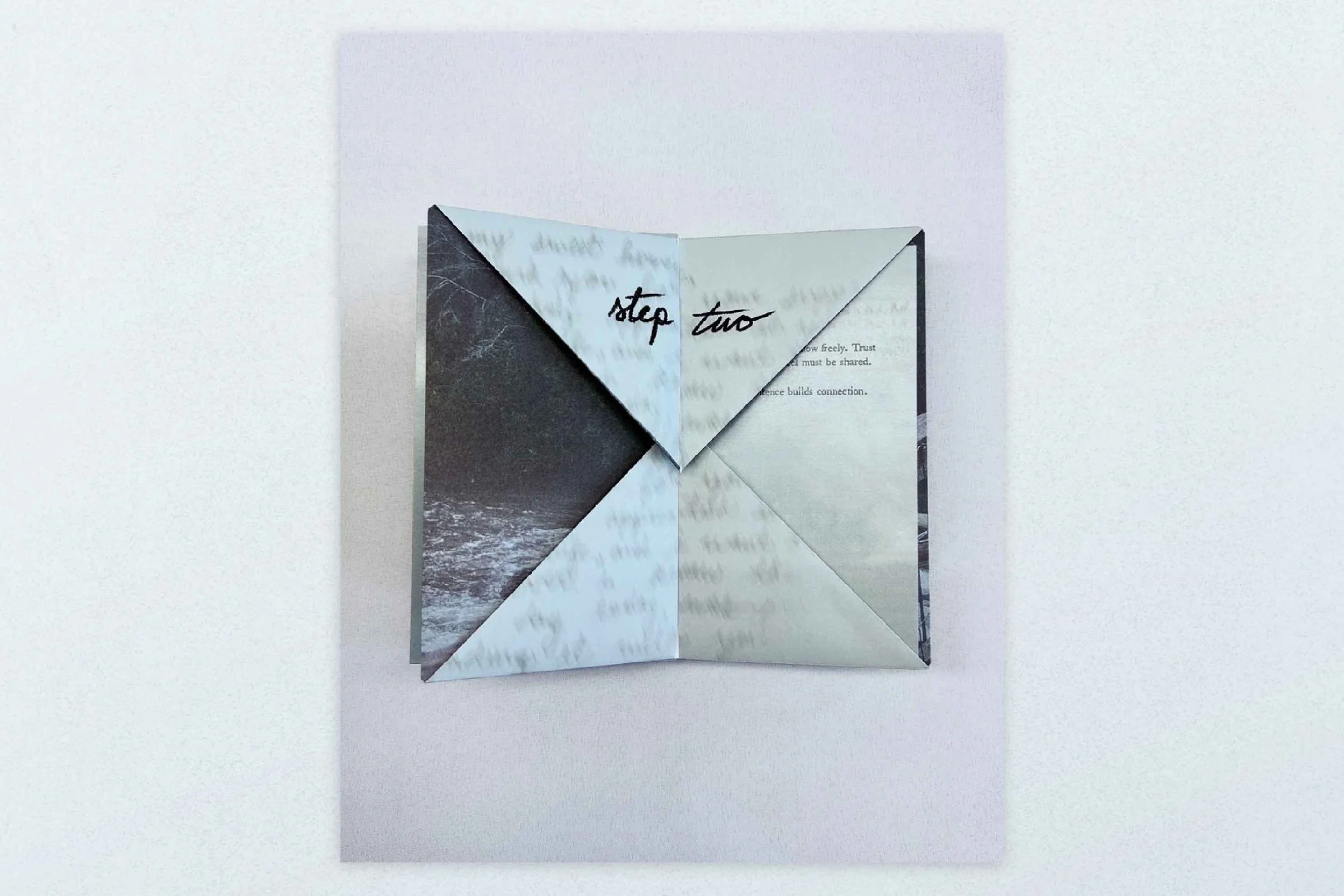 A folded paper with different designs on each panel, showing the words "step two" in the center.