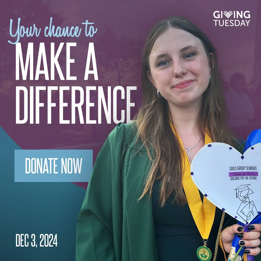 A young woman in a green graduation gown holding a heart-shaped sign that says 'Girls Group Seniors' with a graduation cap illustration, smiling at the camera. The background features purple and teal colors with text promoting giving and donations, a