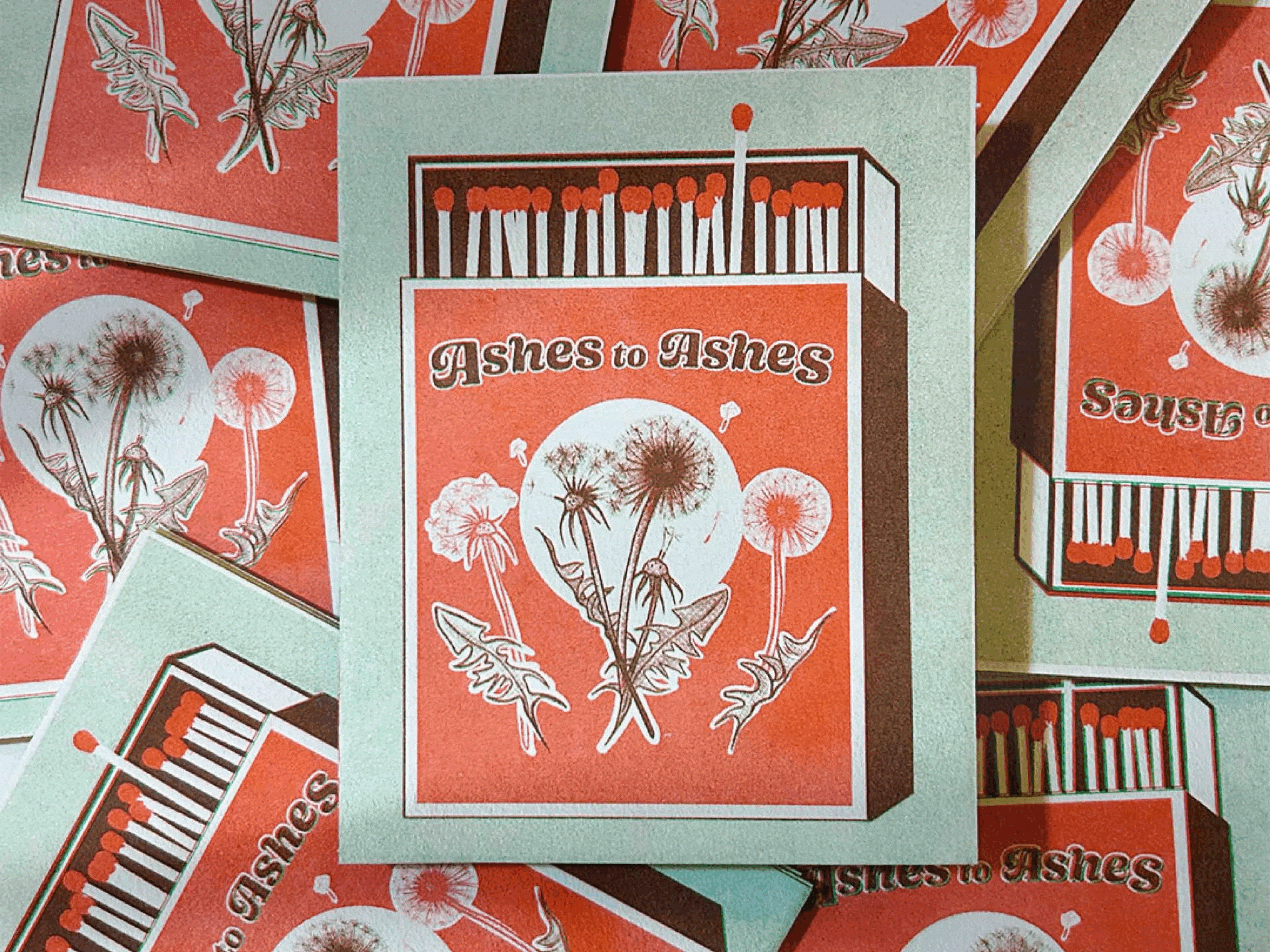 A collection of matchboxes with the design, 'Ashes to Ashes,' displaying dandelion seeds and a matchstick box illustration.