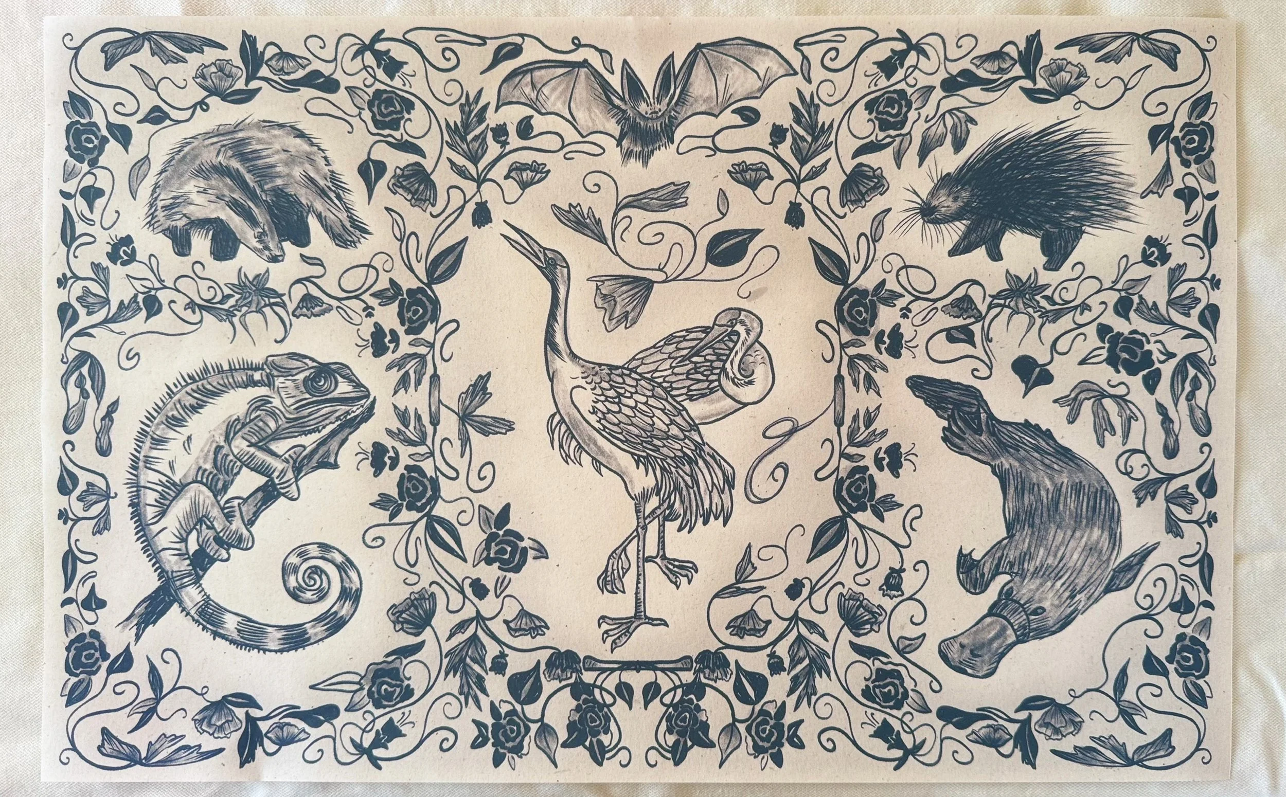 Illustration of various animals including a porcupine, hedgehog, chameleon, heron, turtle, and turtle in a decorative floral frame.