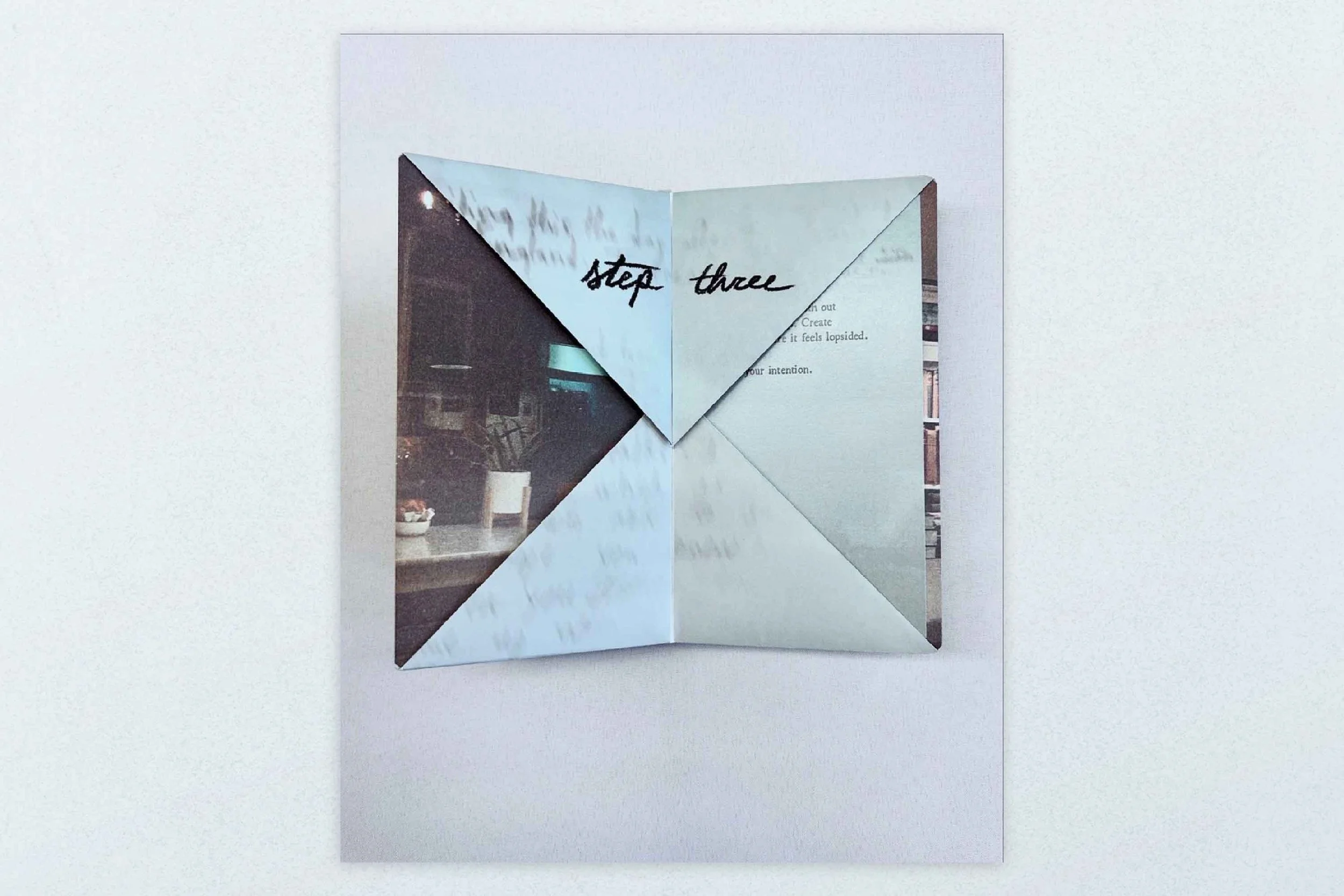 A folded paper with handwritten text saying "step three".