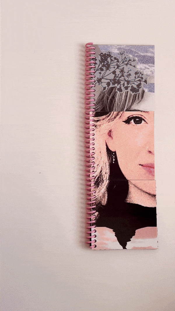 A spiral-bound notebook with a pink spine, decorated with a collage of cut-out images of a woman's face and a nature scene with branches and leaves, lies on a plain white surface.
