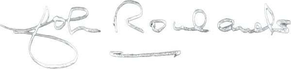 Handwritten signature reading 'Joe Rowlands' with an arrow pointing to the right.