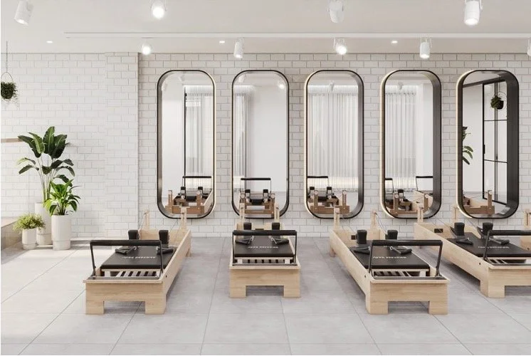 A modern Pilates studio with reformer beds and modern interior.