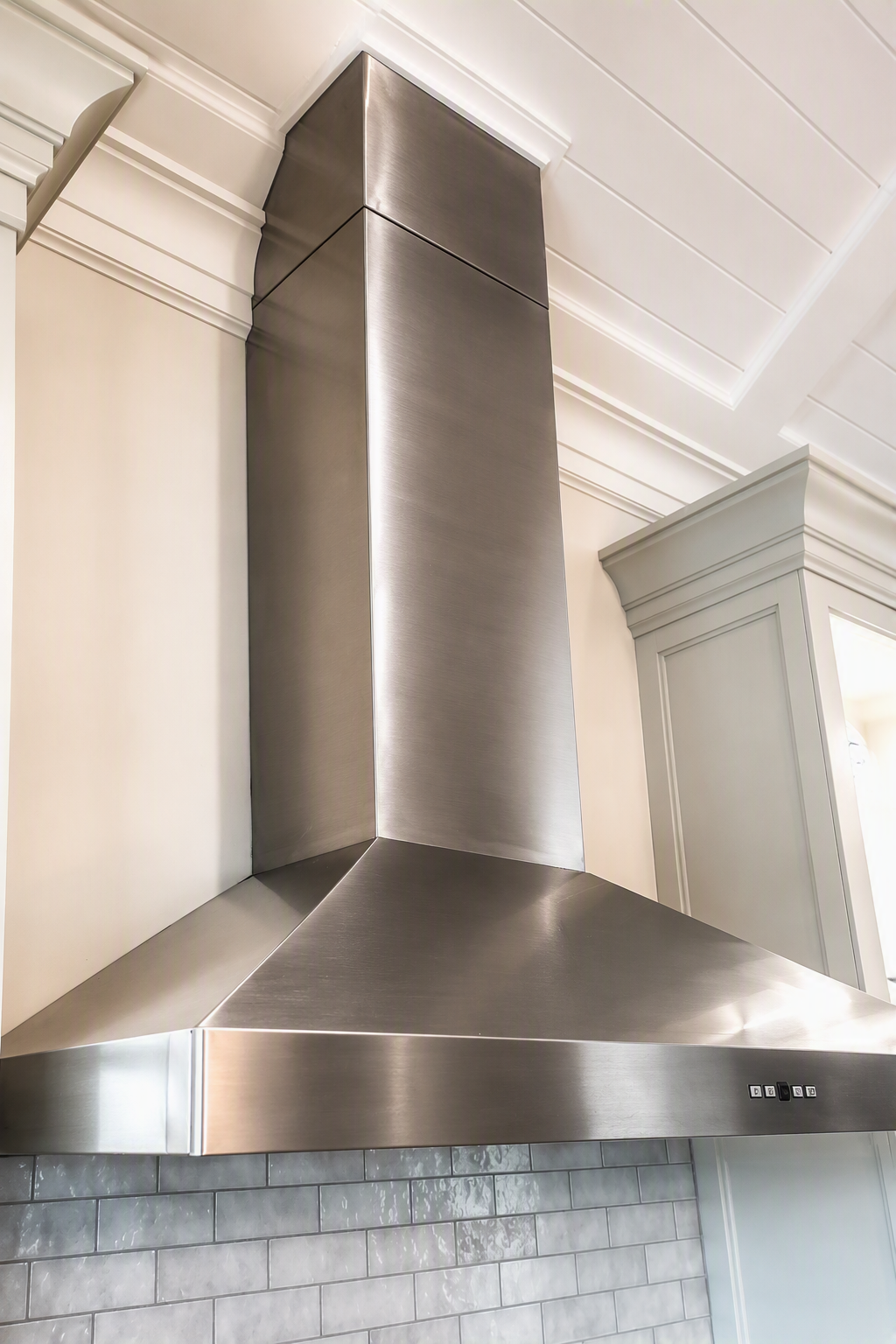 Metal range hood in a home byCustom Copper Co., Newport, RI