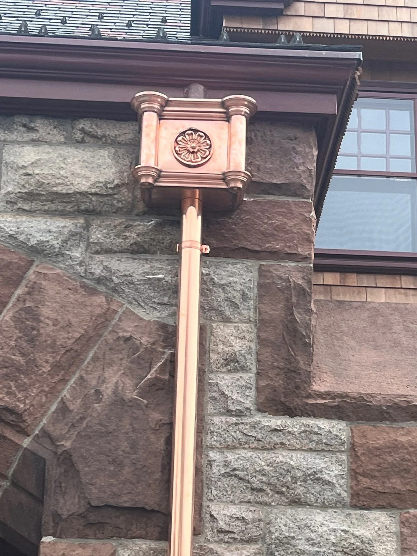 Decorative leader head on a gutter by Custom Copper Co., in Newport, Rhode Island.