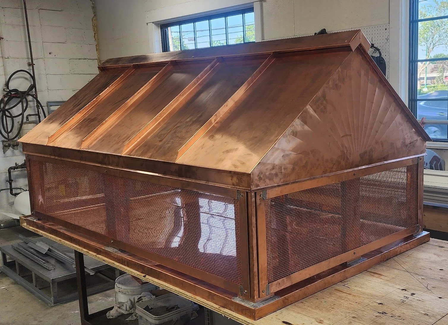Intricate copper chimney cap in the workshop by Custom Copper Co., in Newport, Rhode Island