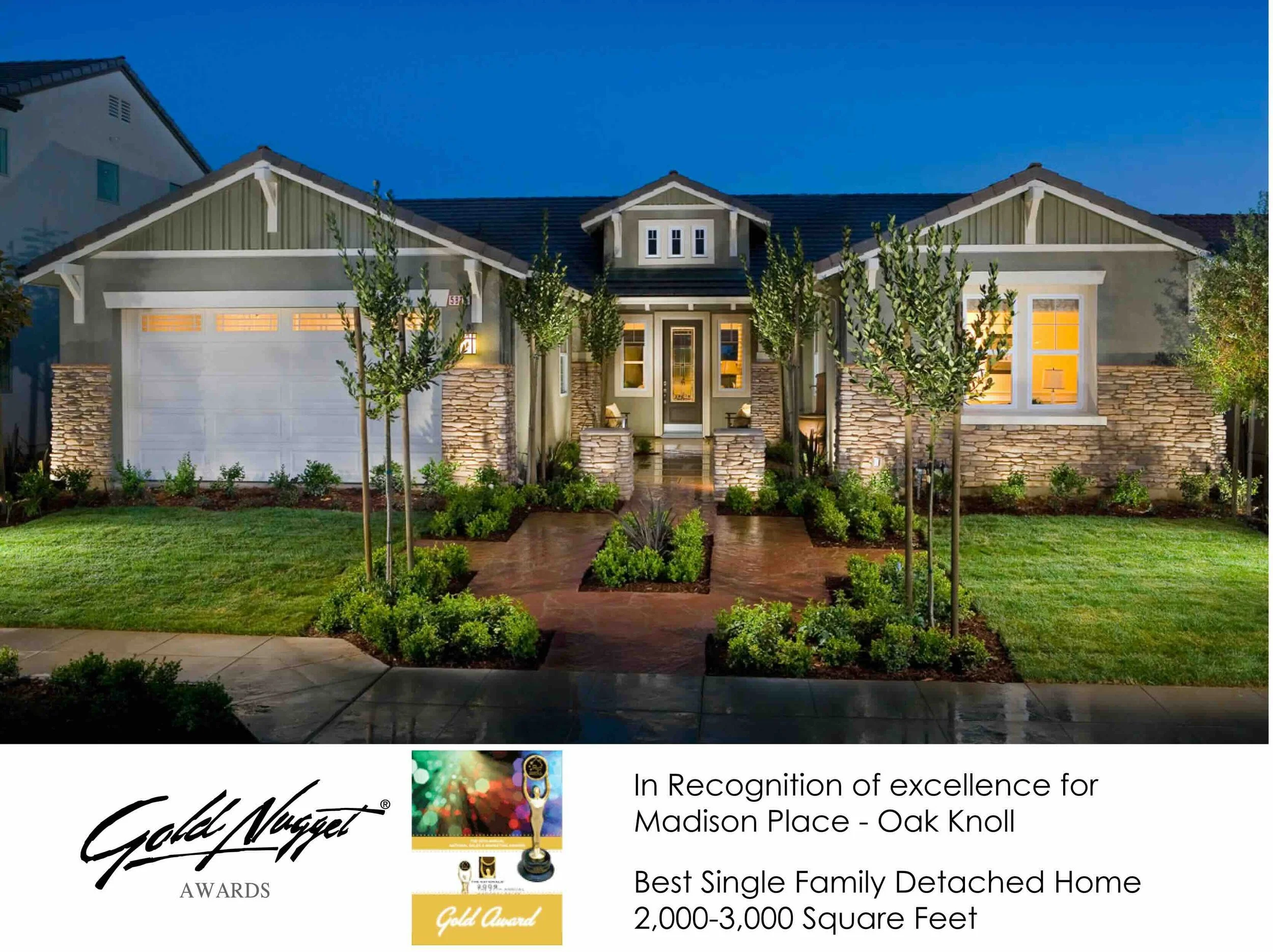 Front view of a single-family detached home with a well-maintained yard and landscaping, taken during evening with lights on inside.