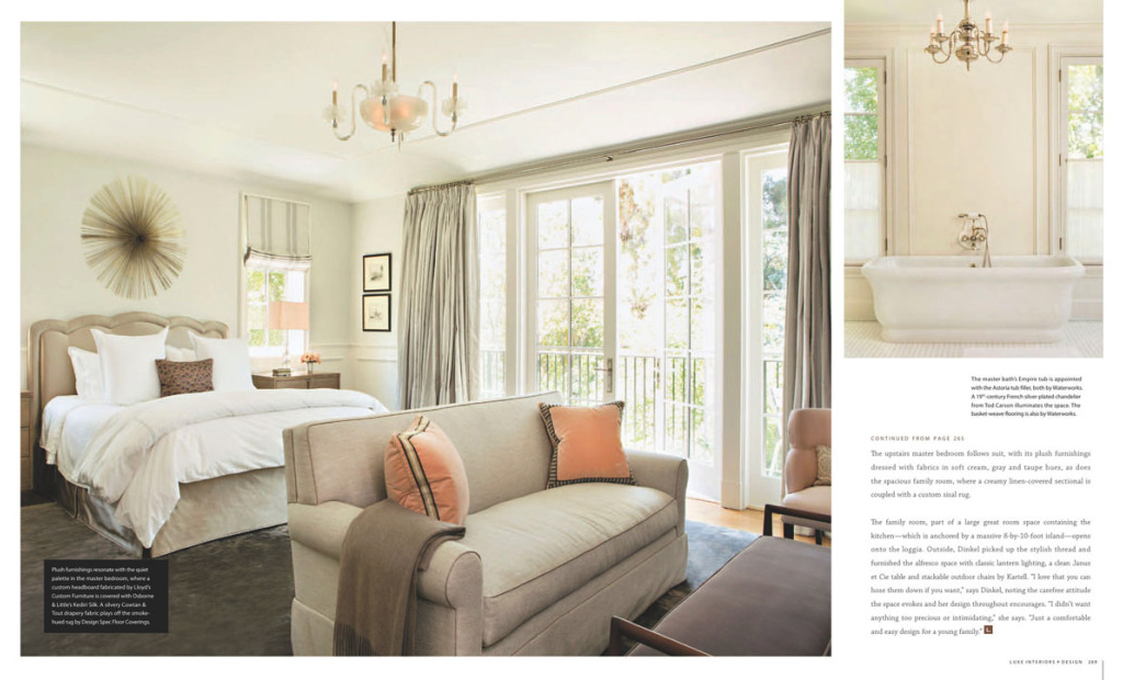 Bright bedroom with large window, beige bed with white bedding, beige sofa, pink and orange throw pillows, chandelier, and balcony view.