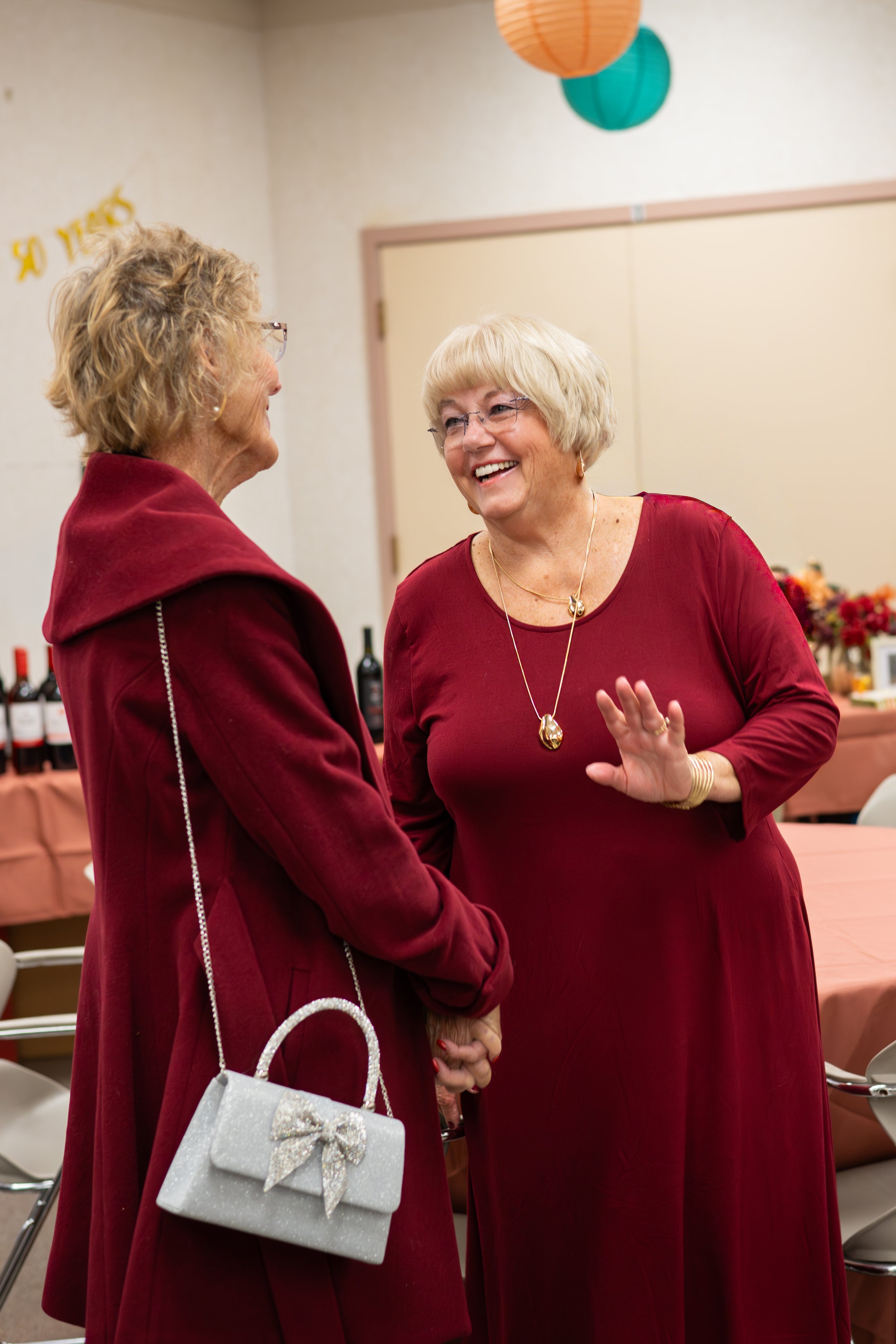 Sean’s customer, Joanne laughing with her friend at her 50th wedding anniversary party.