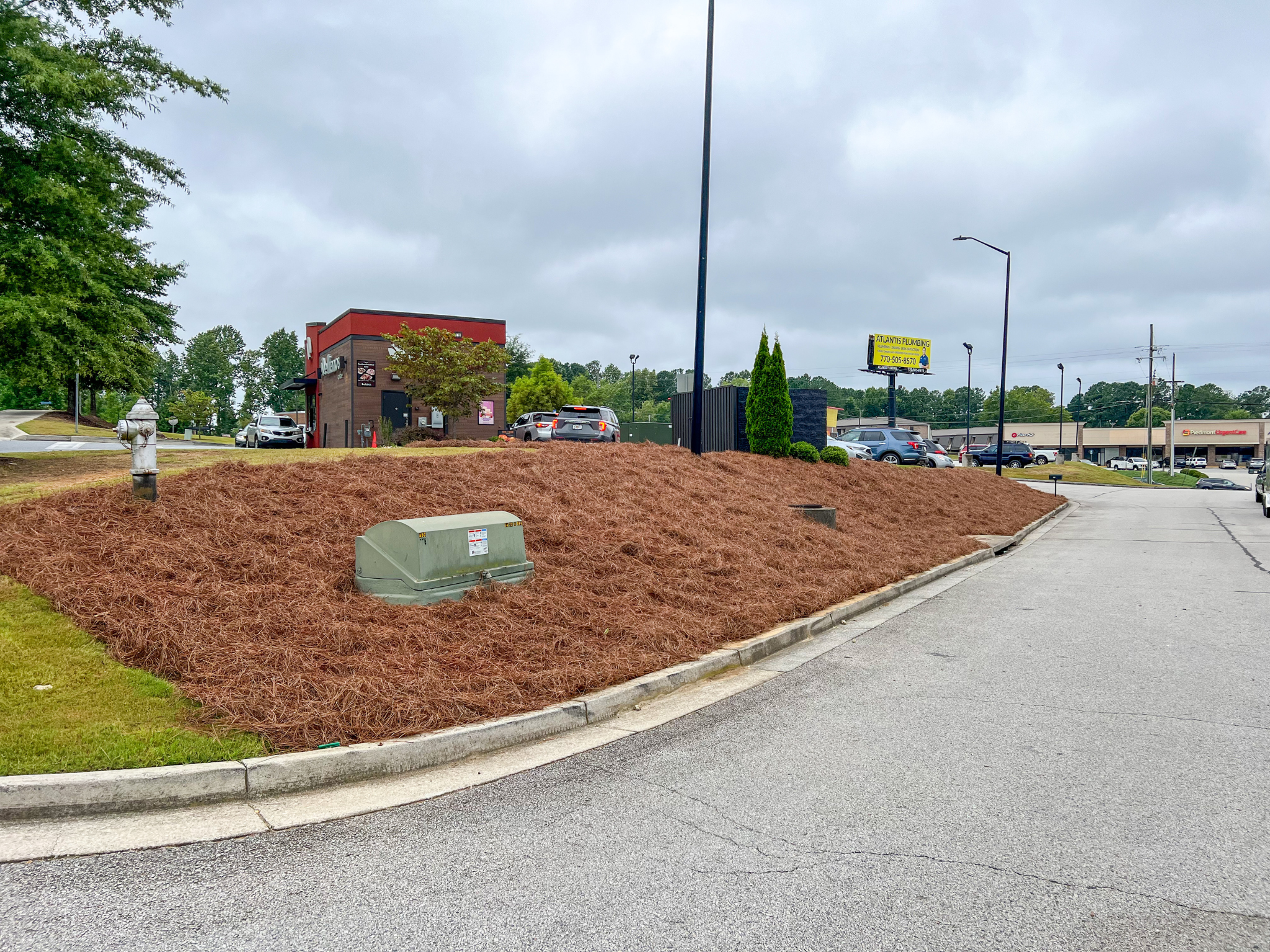 Professional pine straw installation at a commercial property in Metro Atlanta