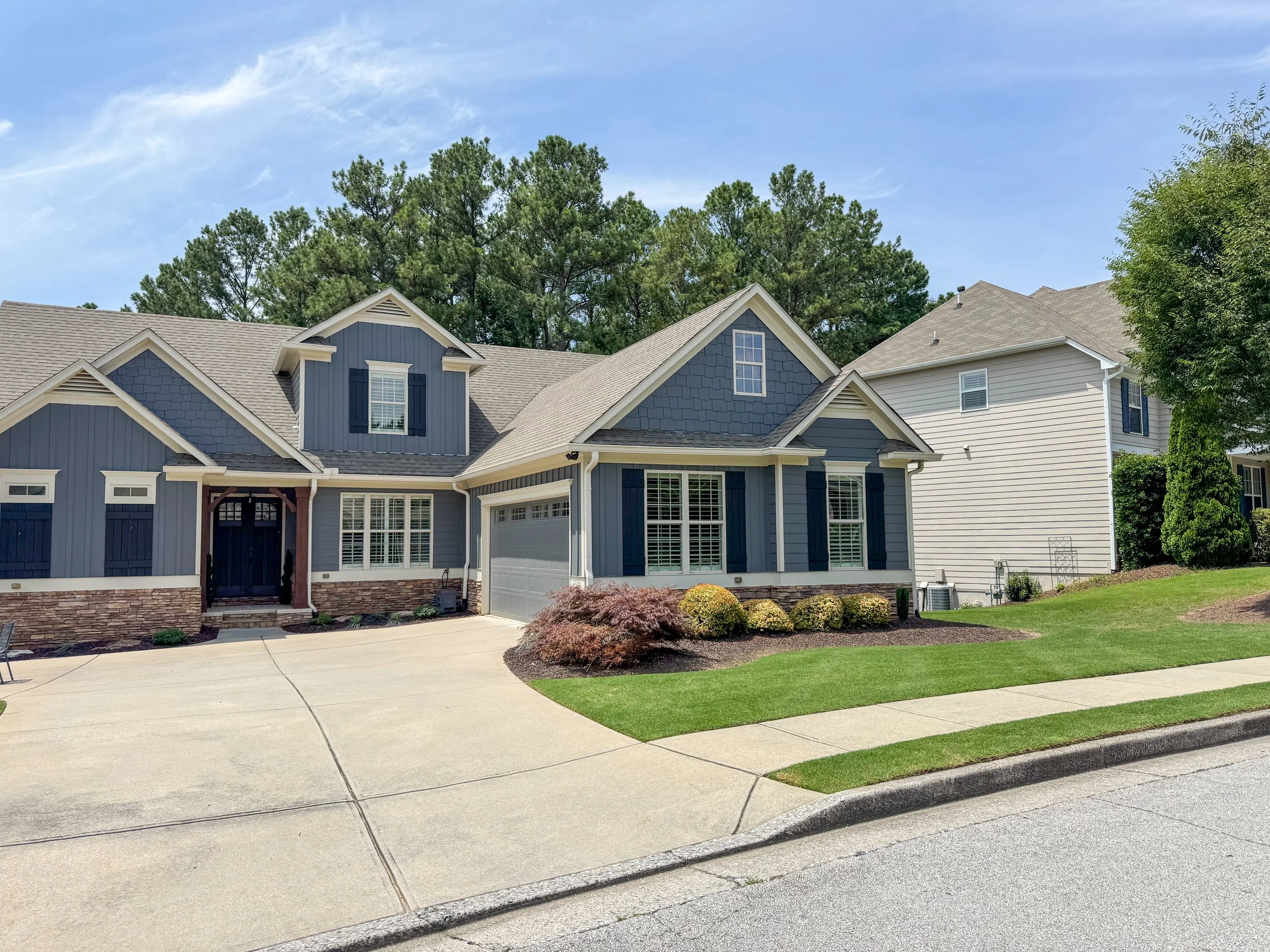 Professional lawn and landscape maintenance with shrub care at a residential home in the Seven Hills subdivision in Dallas, GA
