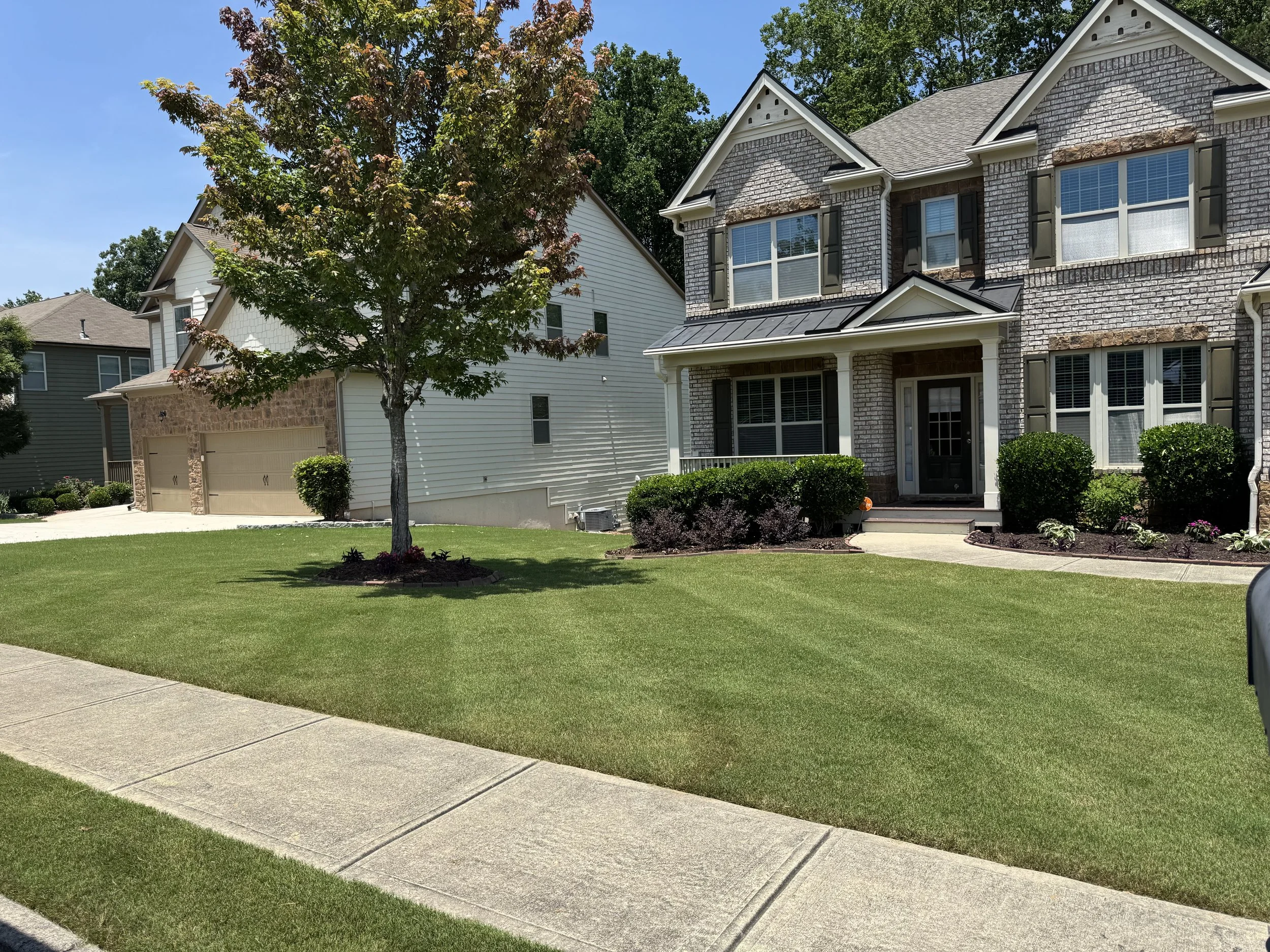 Quality lawn care and landscape maintenance at a residential home in Acworth, GA