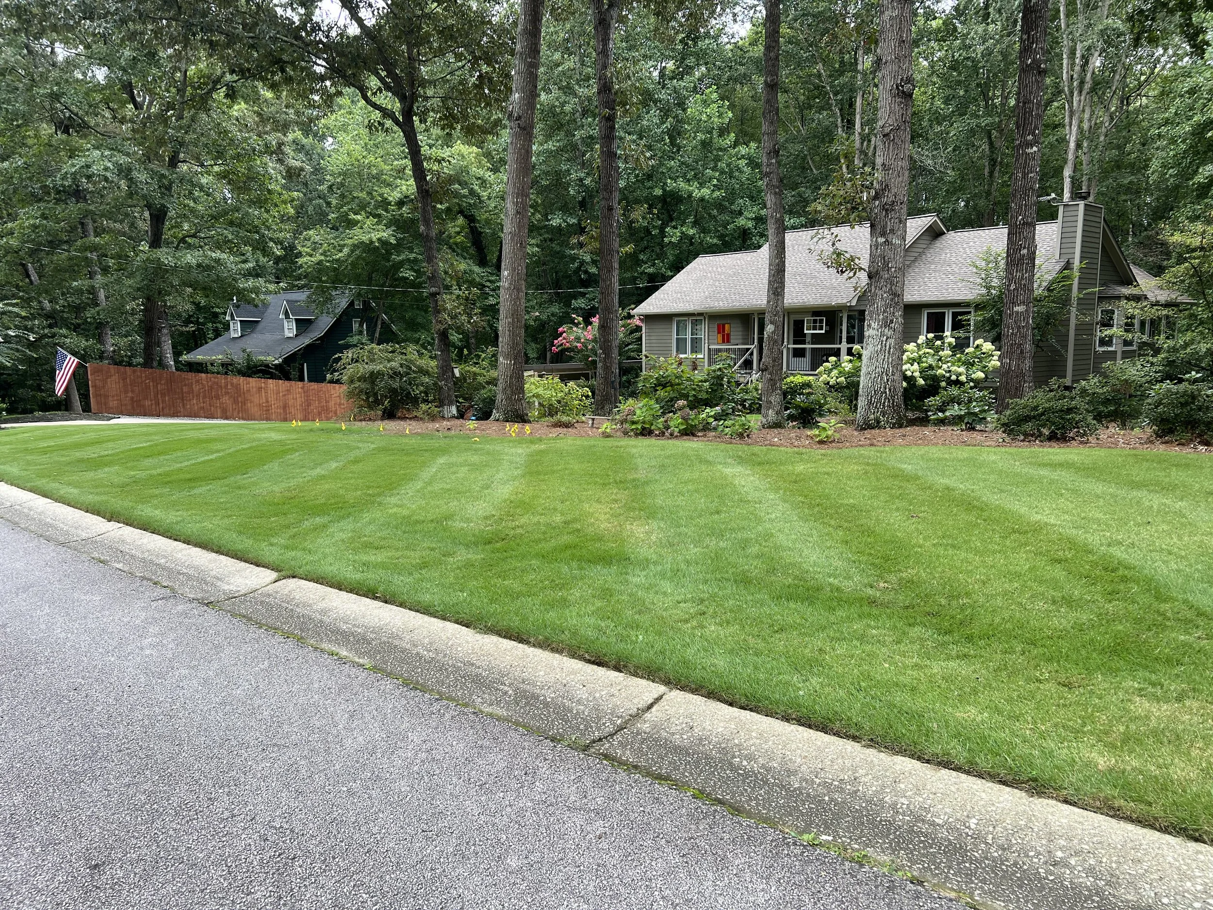 Freshly mowed residential lawn with crisp striping following routine lawn maintenance service in Dallas, GA