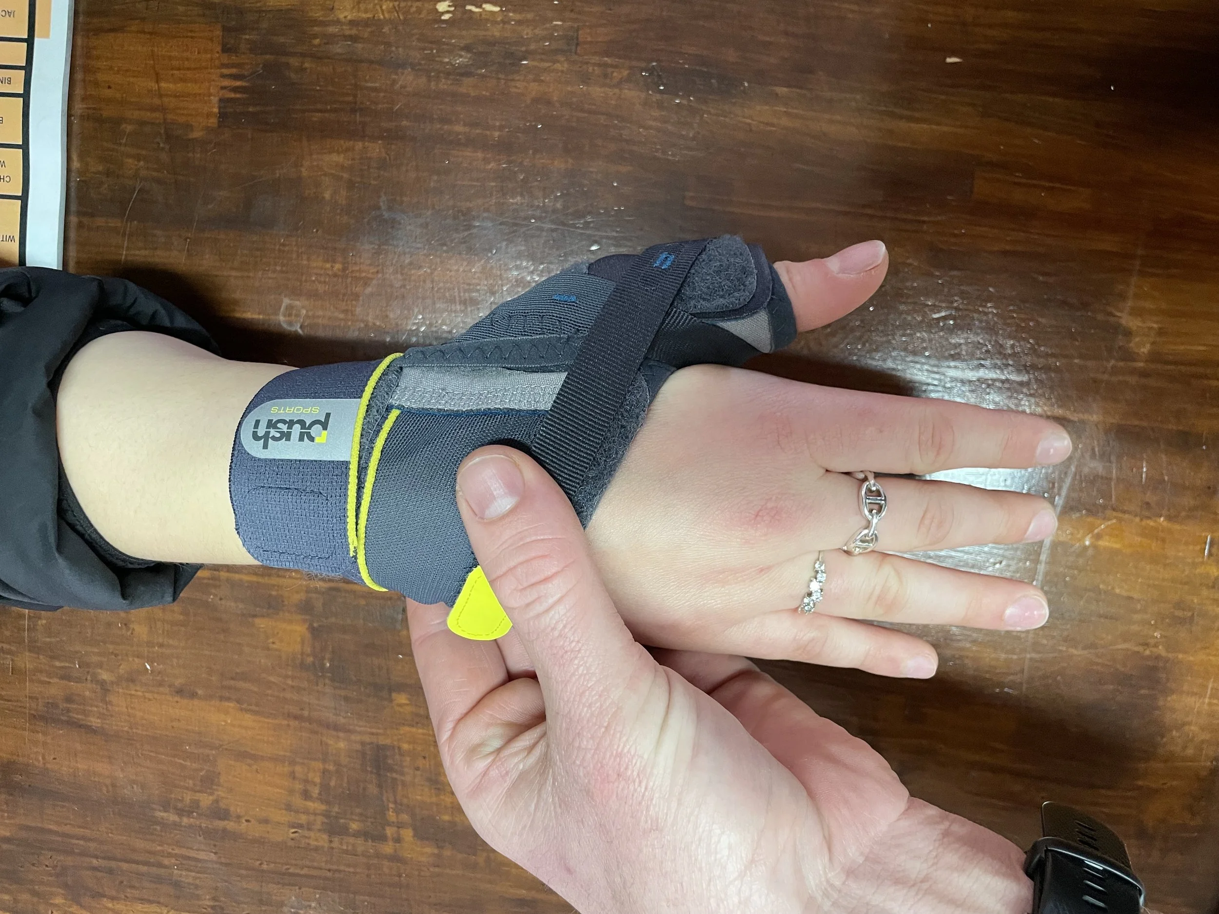 A guest with a skiers thumb injury receives treatment and bracing from Peak Sports Physio Hakuba