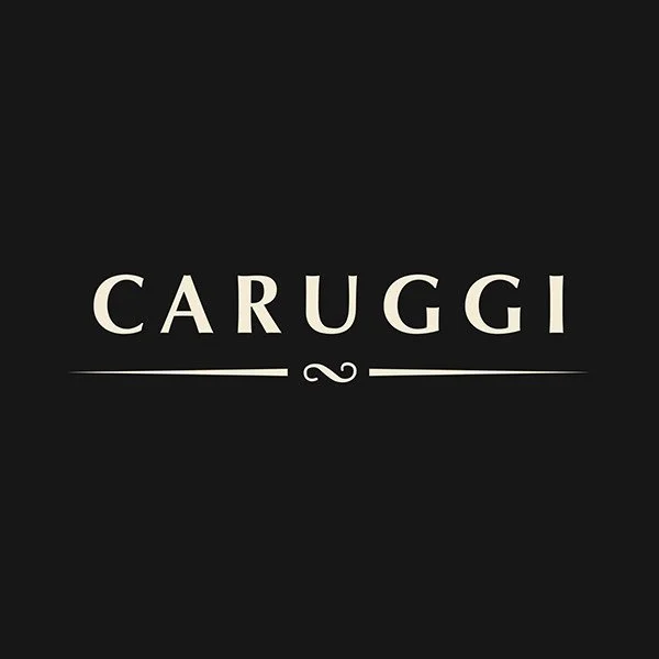 Black background with the word "CARUGGI" in large white letters and a decorative line and swirl below it.