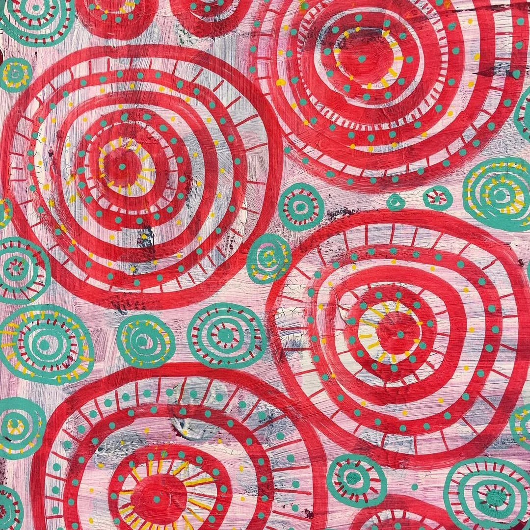 Abstract art featuring large red spirals with dotted patterns in teal, yellow, and pink on a textured background.