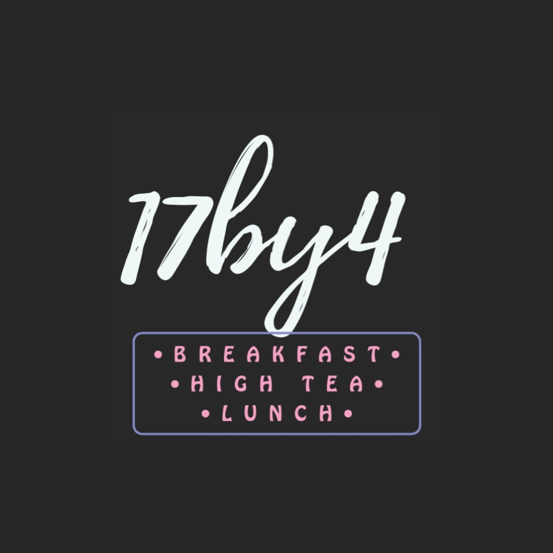 Neon sign with the text '17buz4' and options for 'Breakfast,' 'High Tea,' and 'Lunch' in pink letters inside a purple-bordered box, all on a dark background.