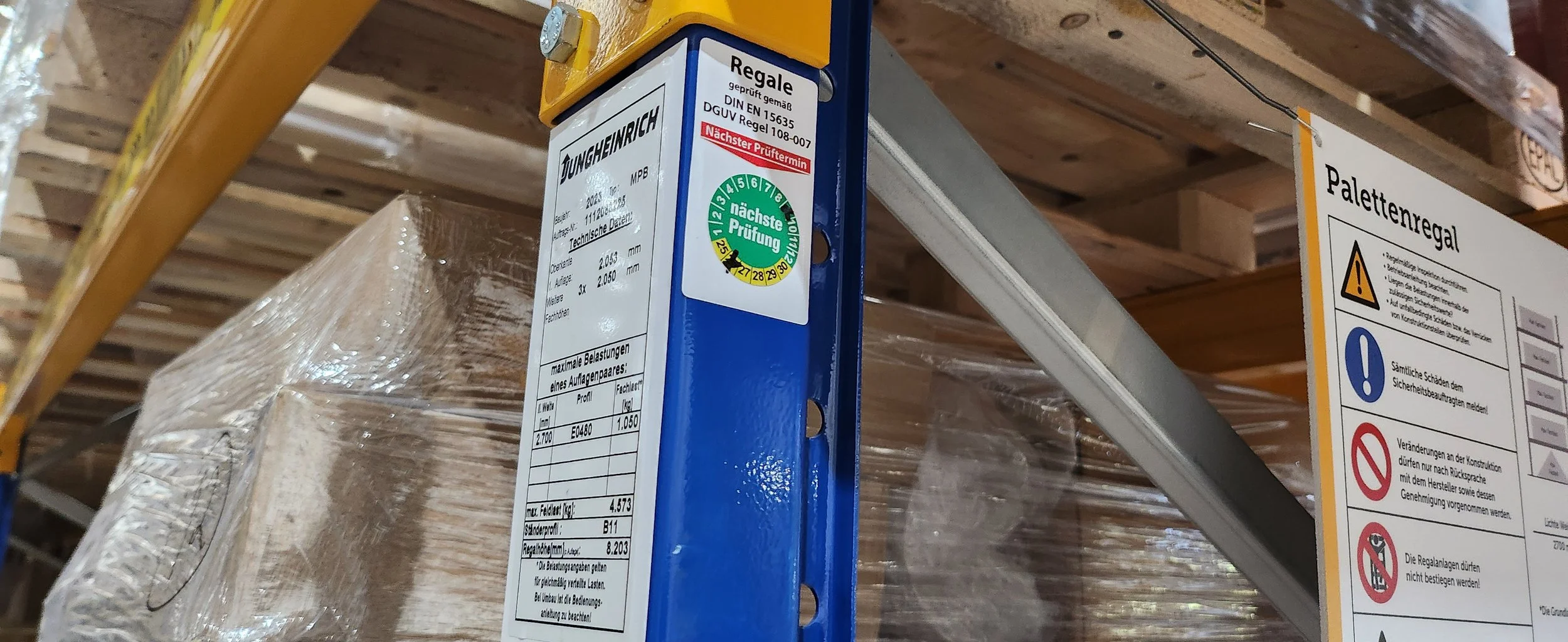 Befestigter Palettenstapel im Lager mit Werkstückträger und Sicherheitskennzeichnung