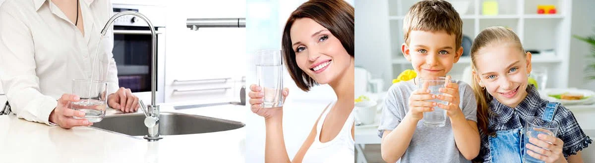 A woman filling a glass of water in the kitchen and two children smiling while holding glasses of water.