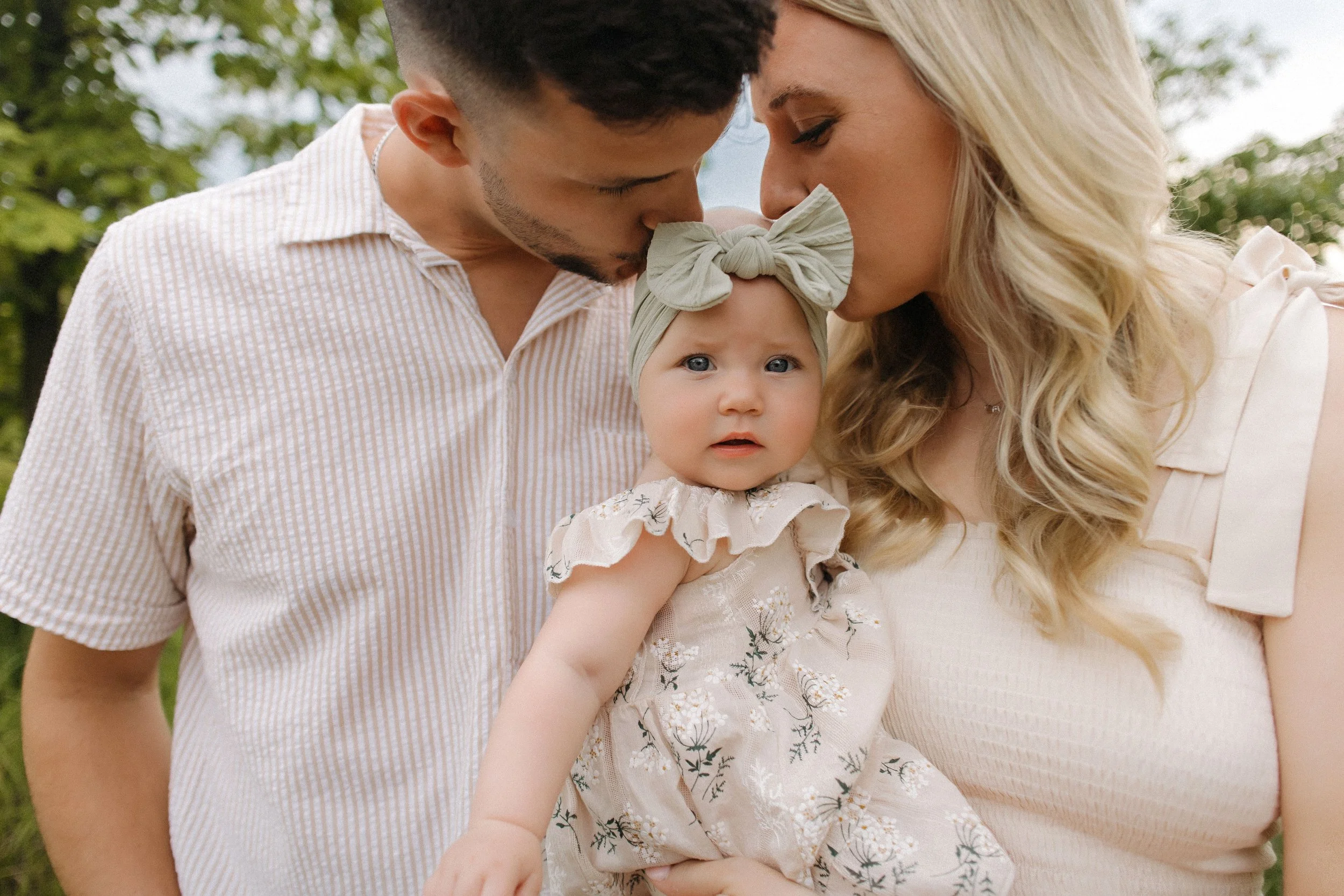 Extended family portrait taken in a park, featuring multiple generations smiling and enjoying their time together
