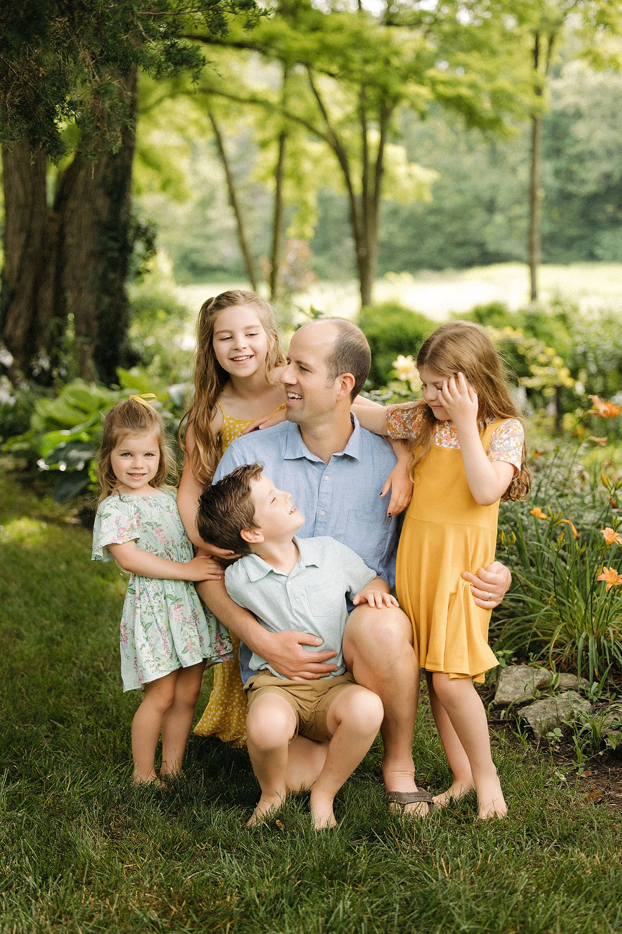  kids laugh with dad in backyard during documentary backyard family photos at home with the heart narrative 