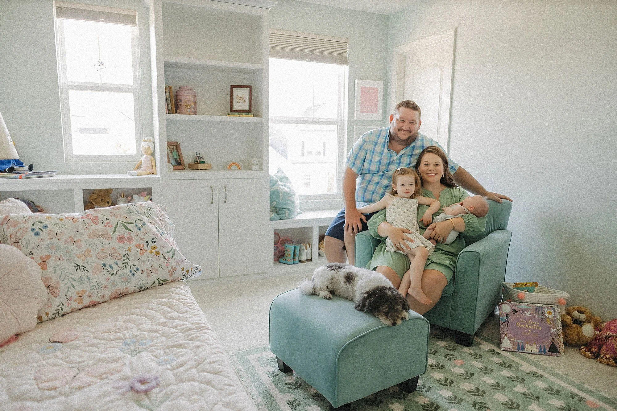 family interacting with newborn baby during lifestyle session at home