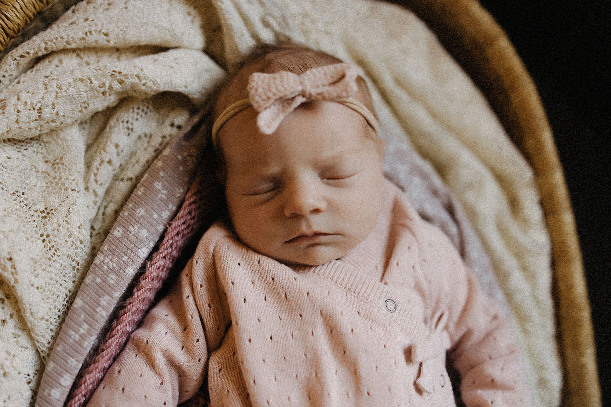  newborn baby sleeping peacefully during in-home session 